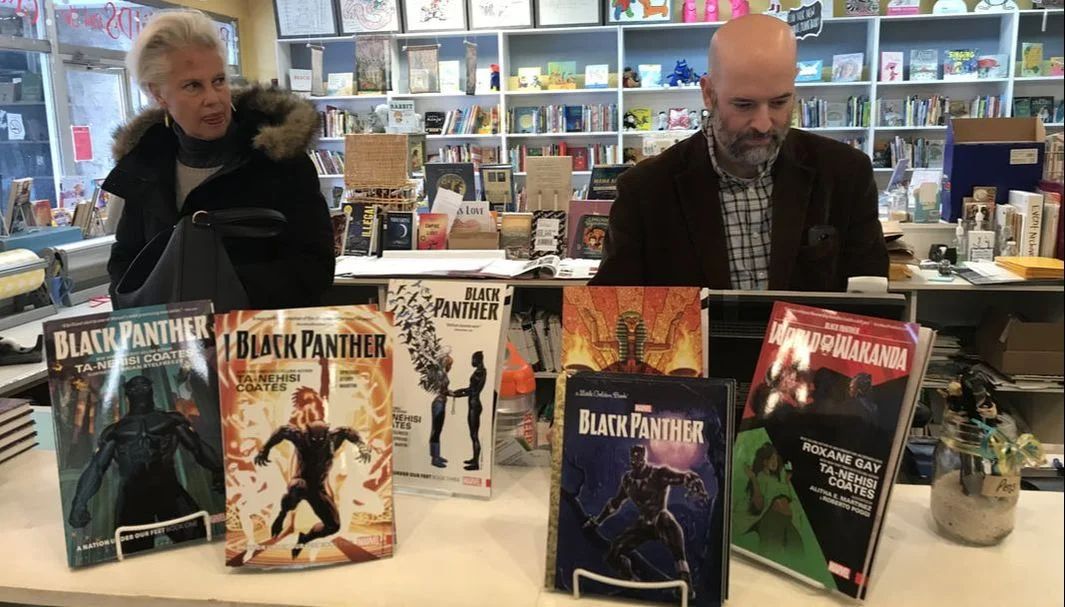 I stealthily snapped this photo of Diane (left) and Justin (right) standing behind this Black Panther display.