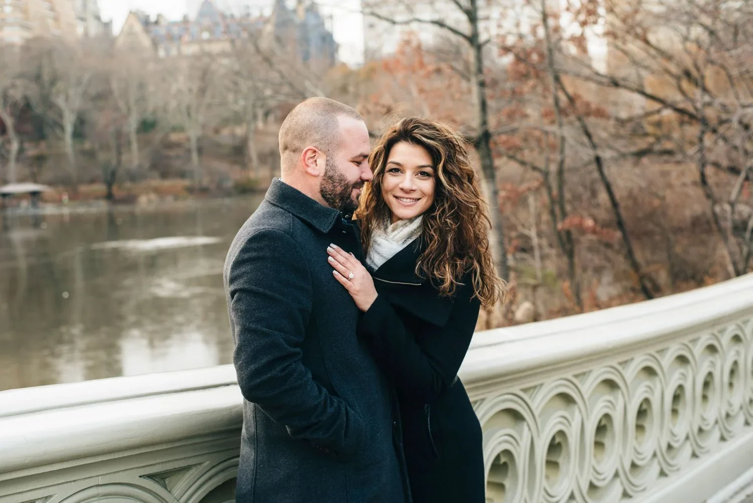 central-park-engagement-couple-smiling-bow-bridge.jpg.webp