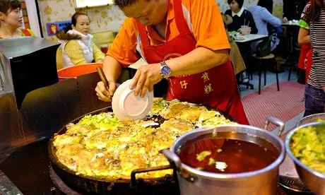 A cook prepares for the evening rush at one of Taipei’s ever-popular street food markets. Photograph: Lap-Fai Lee
