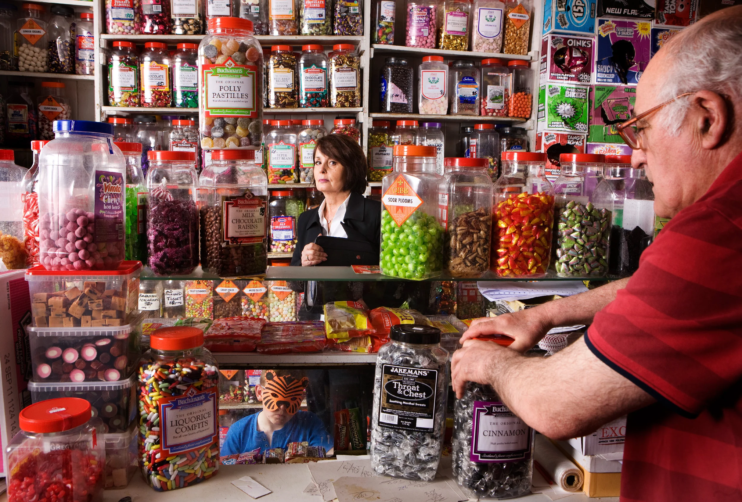 “Look at me standing next to the Soor Plooms with a soor face – that’s just not me”: the writer’s mother, Christine, in Tom Swan’s Sweet Shop in Renton. Photograph: Murdo Macleod for the Observer