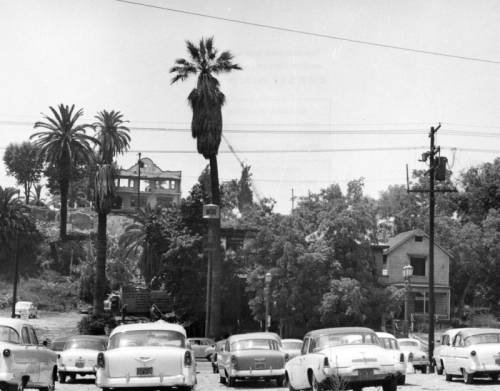 cars parked in front of Bunker Hill Los Angeles with a building being demolished in the distance