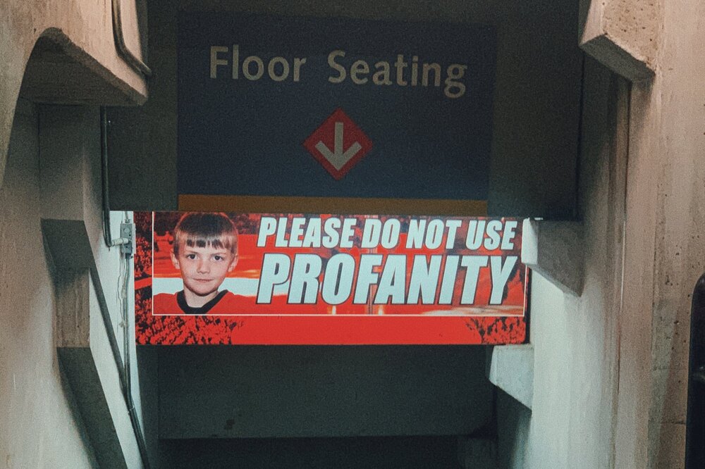 a delightfully inexplicable sign in the context of a hockey arena
