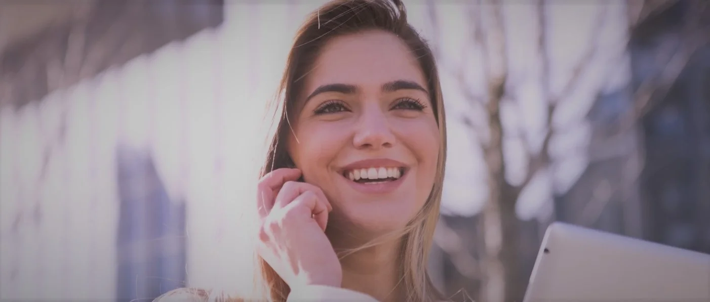 Smiling woman using unified communications