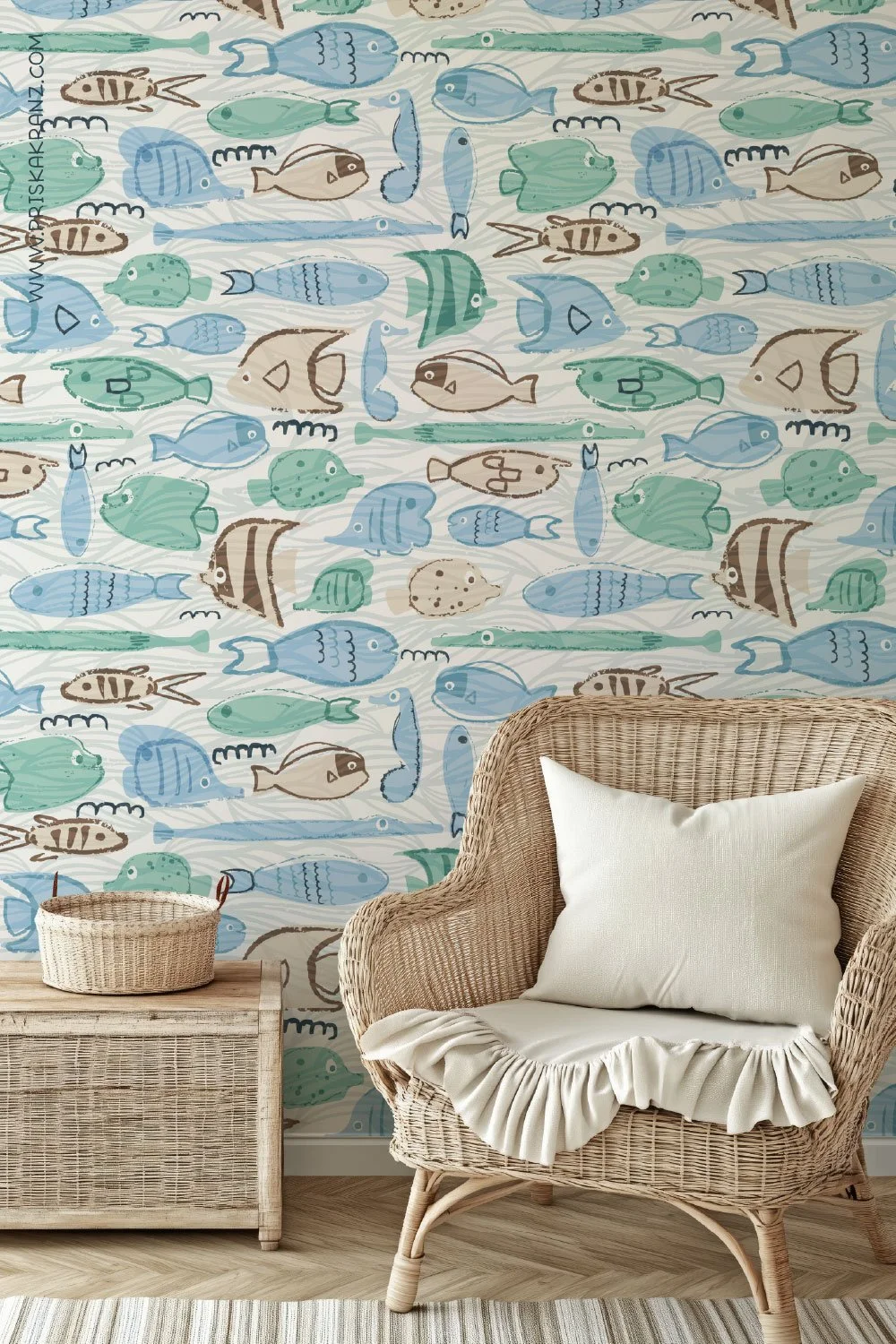 Coastal hand drawn fish pattern wallpaper in soft aqua and blue tones, styled with a rattan chair, neutral cushion, and natural wood furniture.