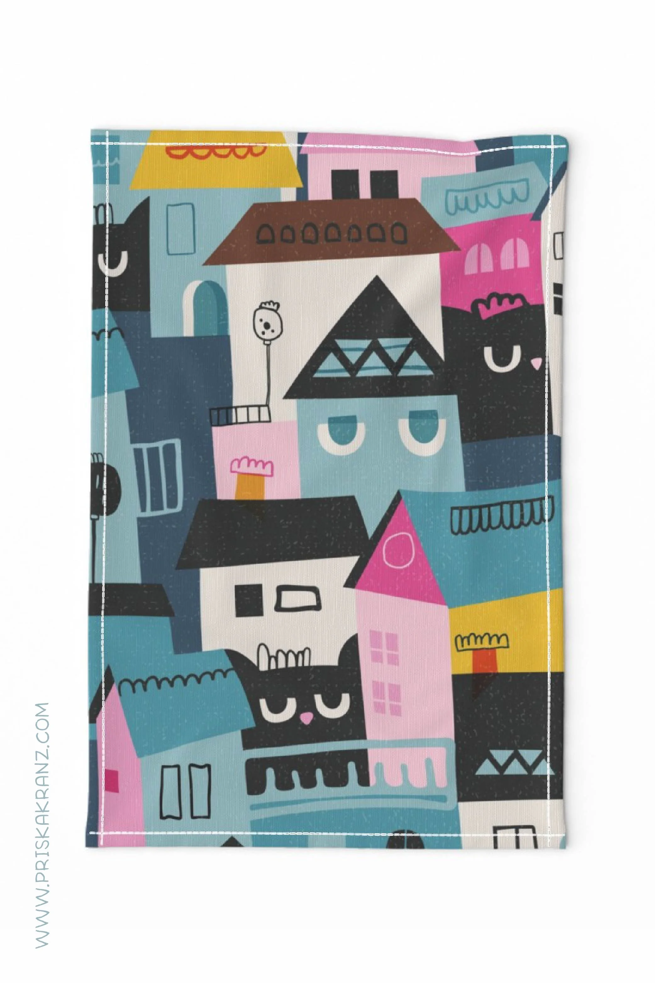 Tea towel showing giant black cats faces between abstract houses in blue, magenta, yellow, white, brown and black