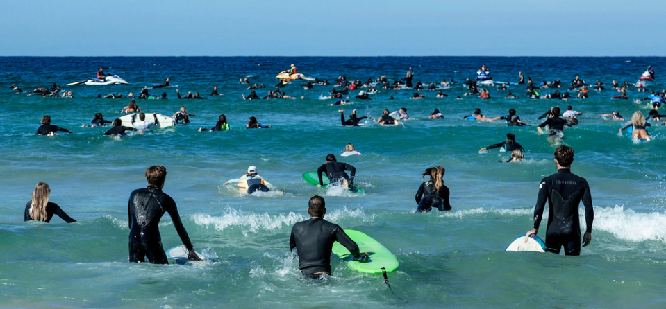 Surfers paddling out through the breakers at Bondi Beach in Sydney, Australia, on Sunday in protest against oil and gas drilling in the Great Australian Bight. Credit: Anna Maria Antoinette D’Addario for The New York Times