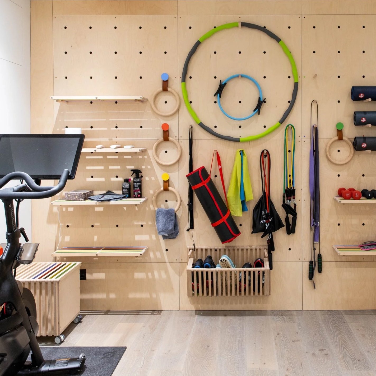 an interior laundry room which shows furniture design and made by the dual works, this includes clothes drying racks and feature doors, linear in style. made form birch plywoood which gives a calm ambience