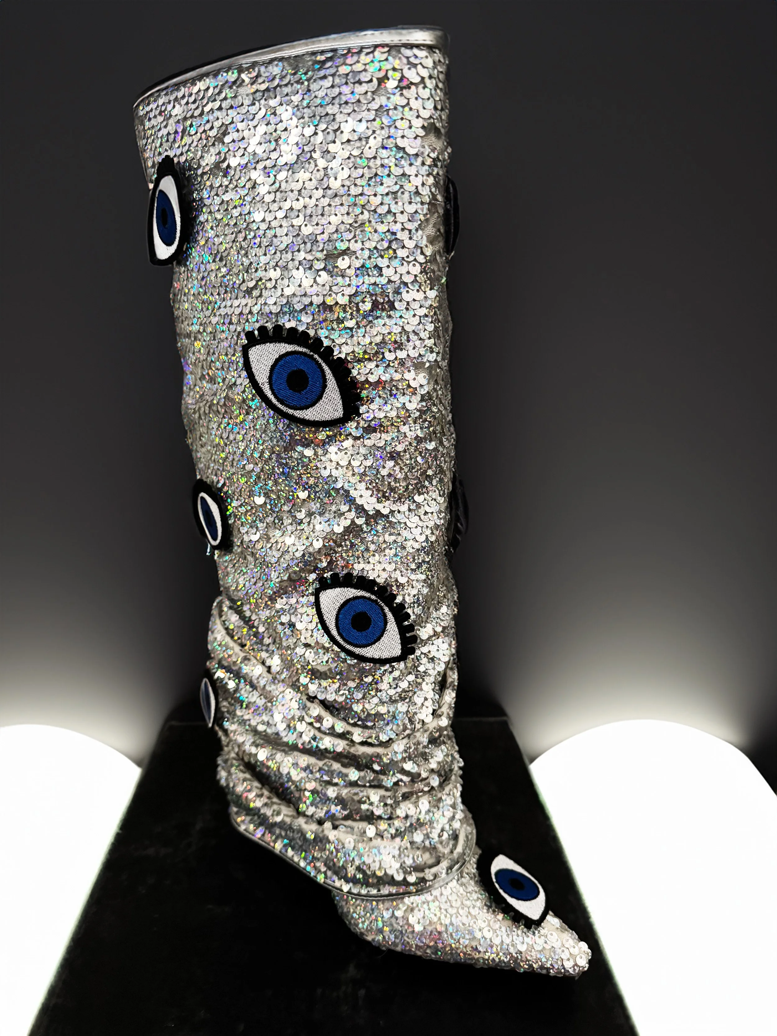 One-of-a-kind silver sequin boots embellished with embroidered evil eye patches, designed by artist Charity Huether. Mid-calf stiletto heel, size 8.5.