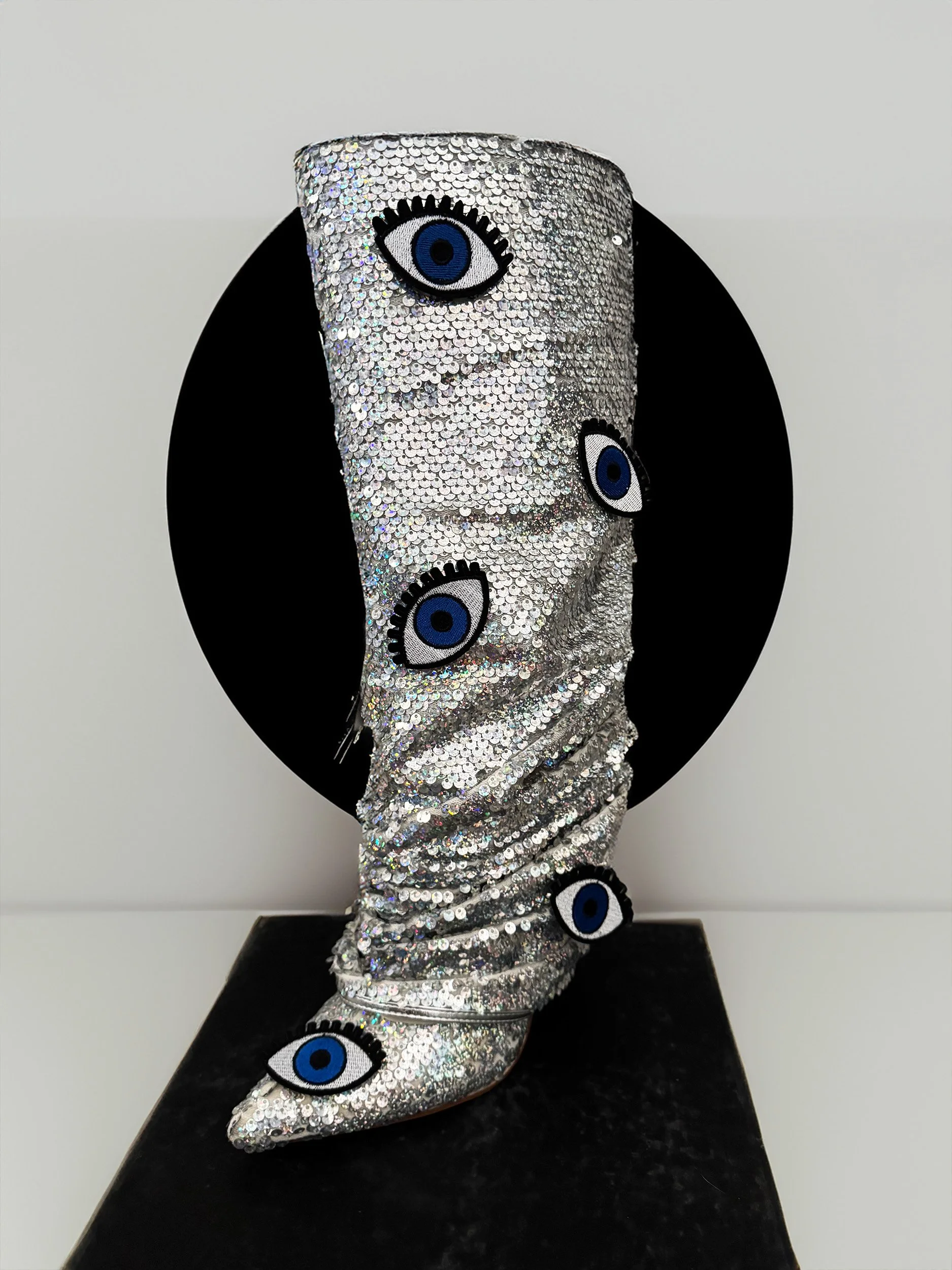 One-of-a-kind silver sequin boots embellished with embroidered evil eye patches, designed by artist Charity Huether. Mid-calf stiletto heel, size 8.5.