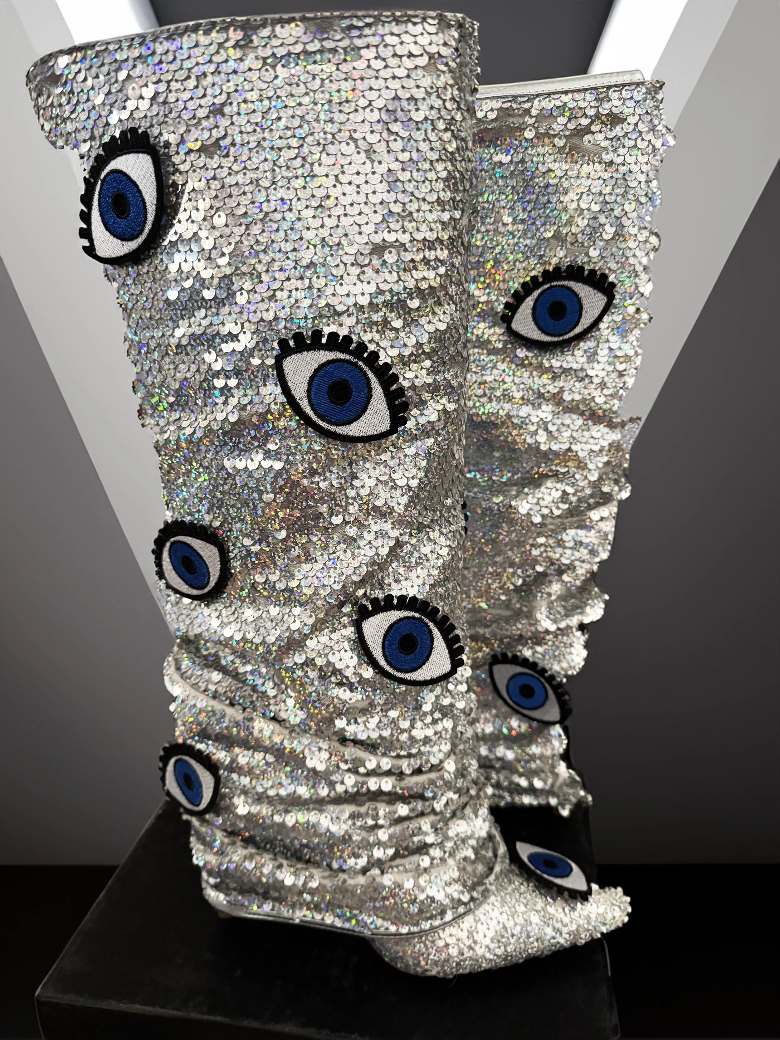 One-of-a-kind silver sequin boots embellished with embroidered evil eye patches, designed by artist Charity Huether. Mid-calf stiletto heel, size 8.5.
