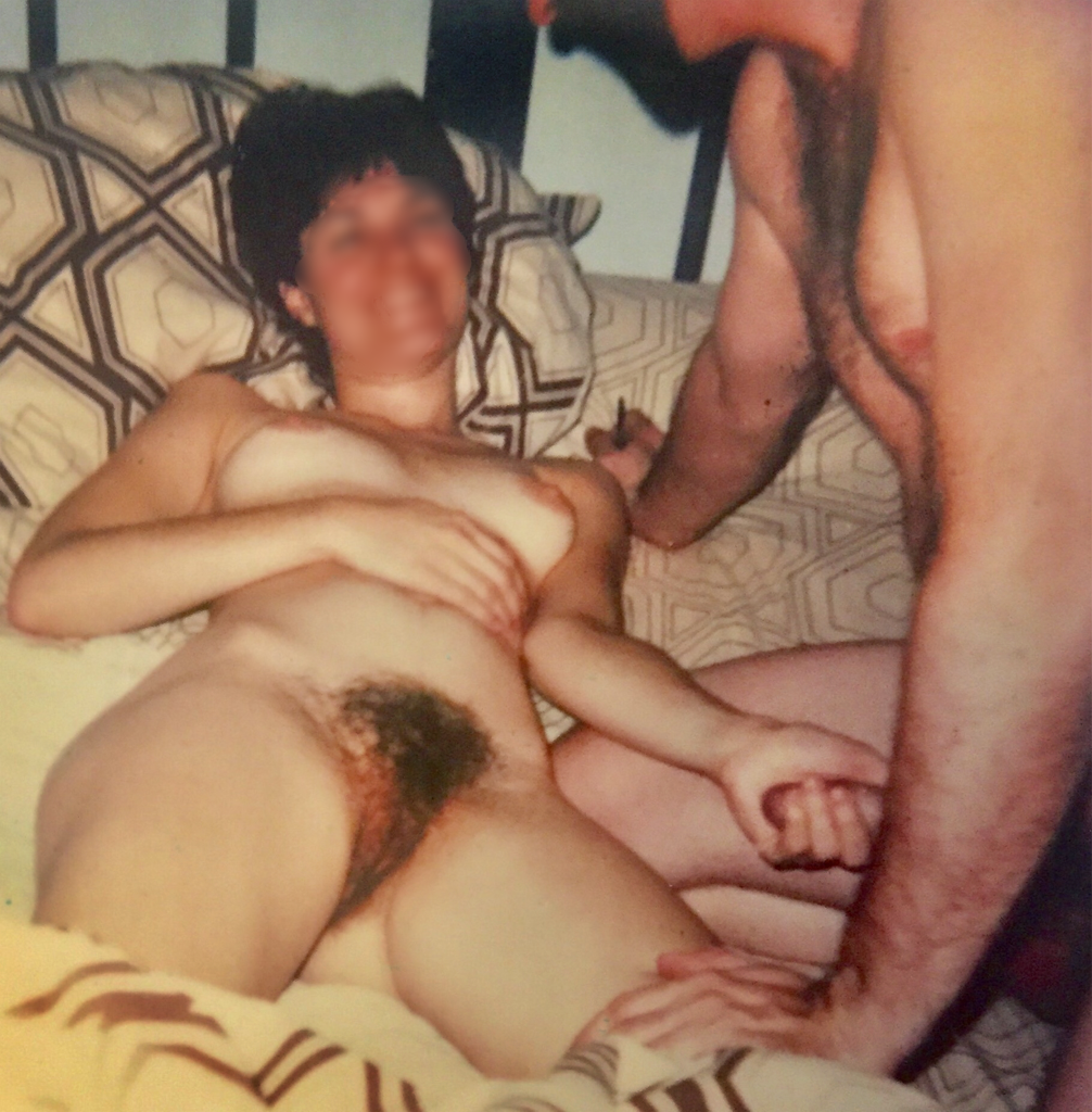 An old Polaroid of my wife holding my erect cock as we began foreplay.png