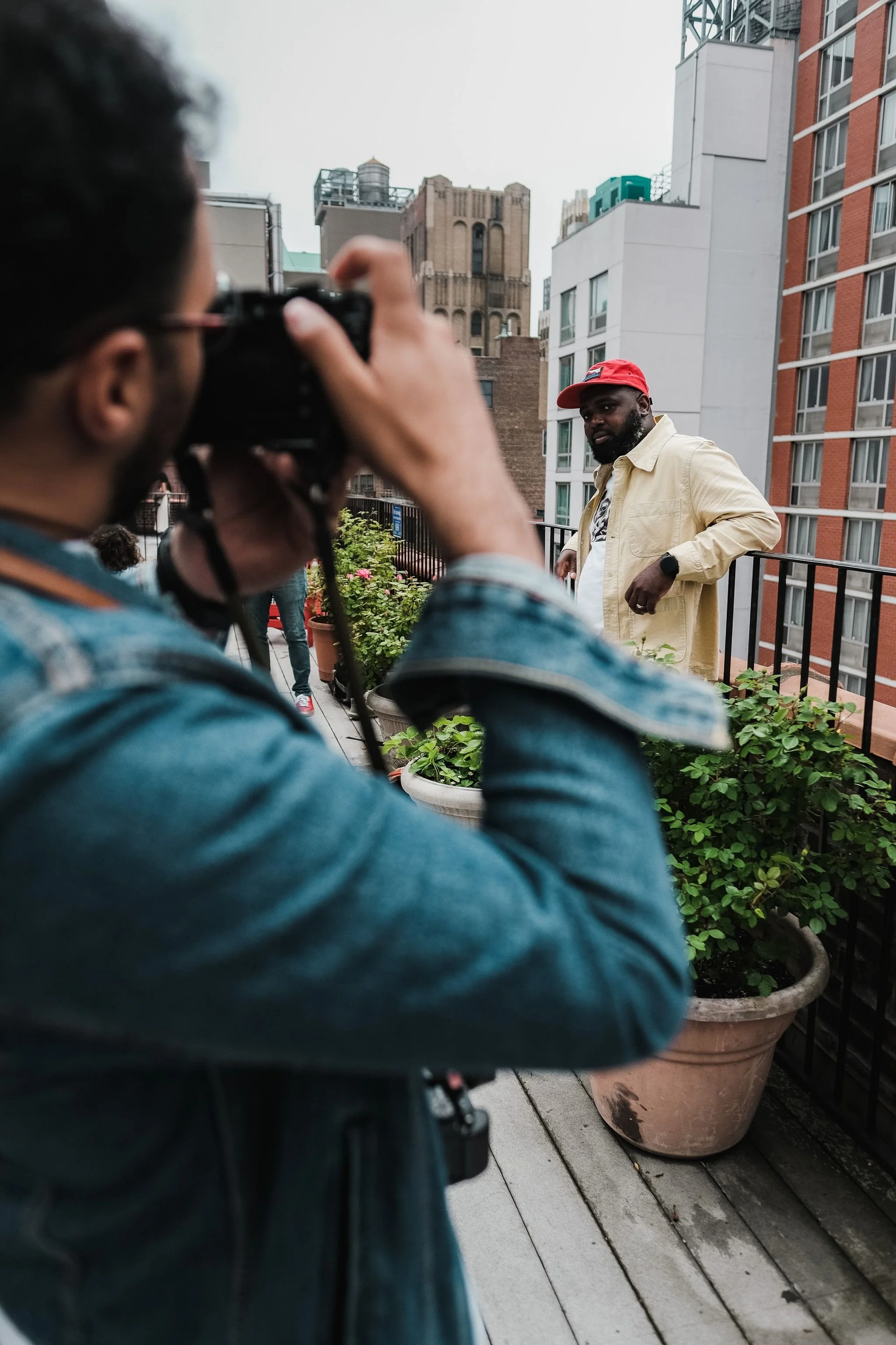 A photographer captures a client portrait during an on-location city session.