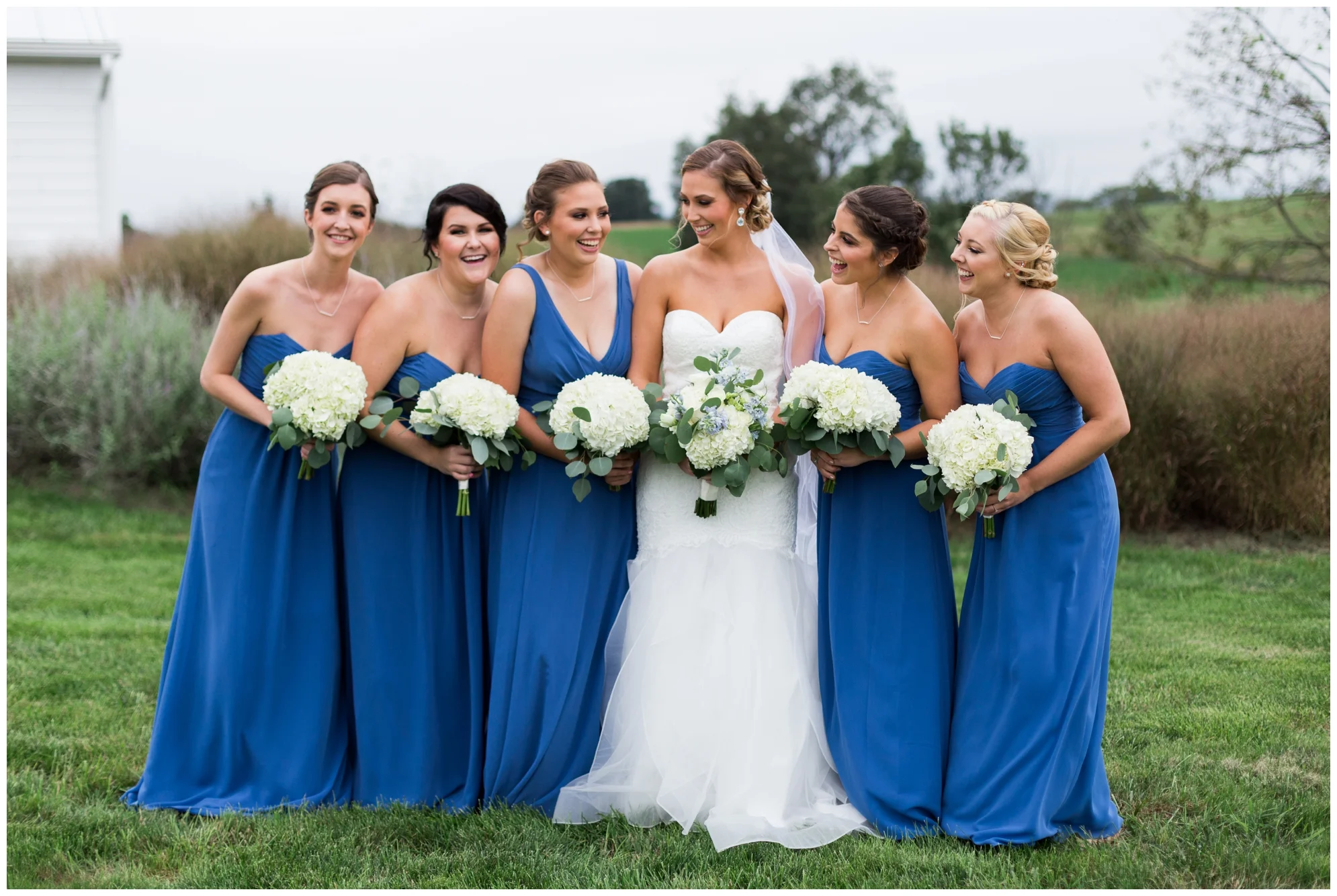 Rainy fall wedding featuring dusty blue bridesmaid dresses, bow ties and a cathedral veil at On Sunny Slope Farm in Harrisonburg, Virginia.