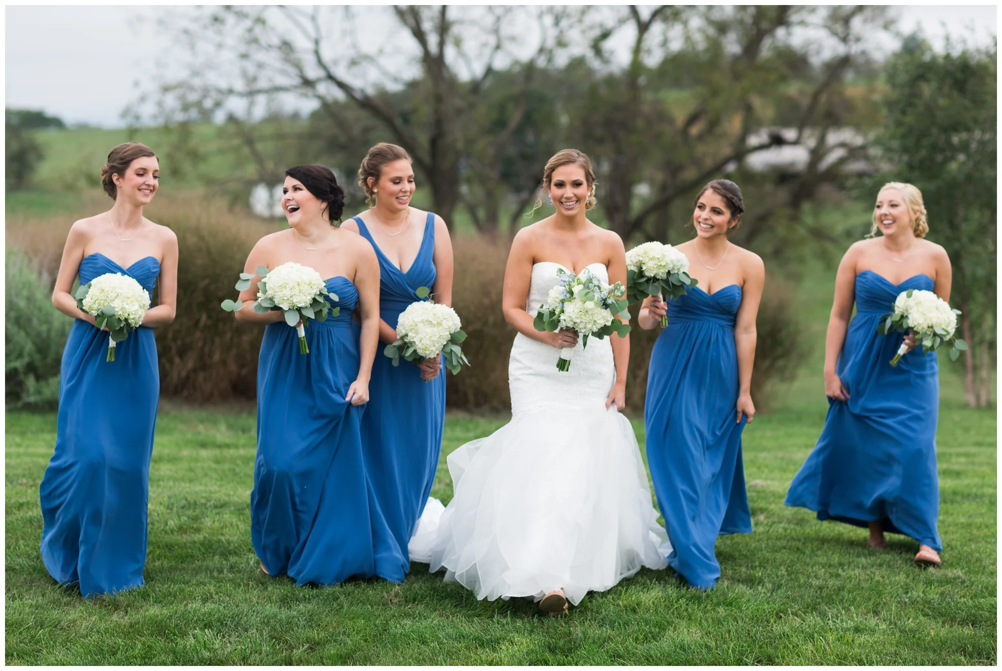 Rainy fall wedding featuring dusty blue bridesmaid dresses, bow ties and a cathedral veil at On Sunny Slope Farm in Harrisonburg, Virginia.