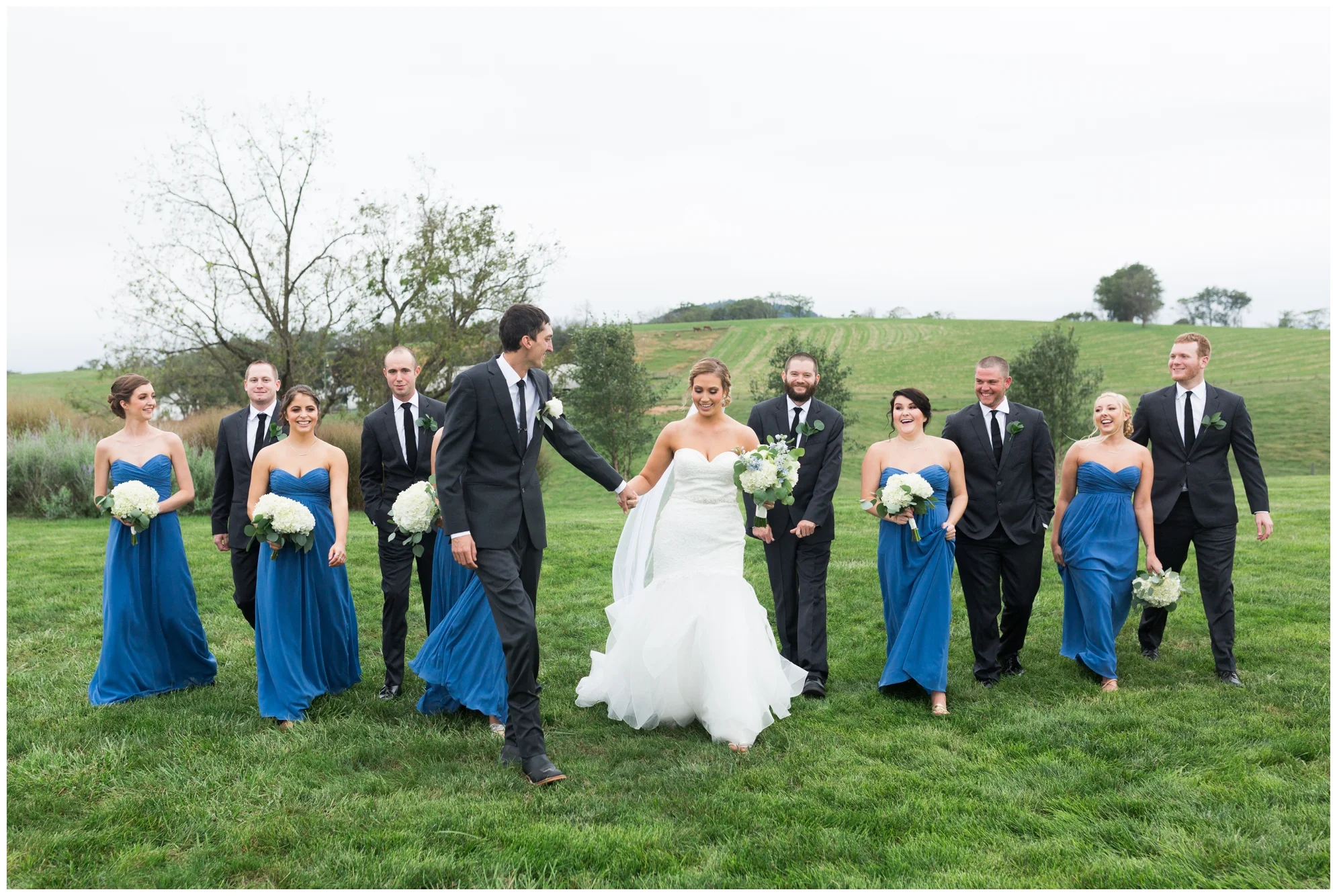 Rainy fall wedding featuring dusty blue bridesmaid dresses, bow ties and a cathedral veil at On Sunny Slope Farm in Harrisonburg, Virginia.