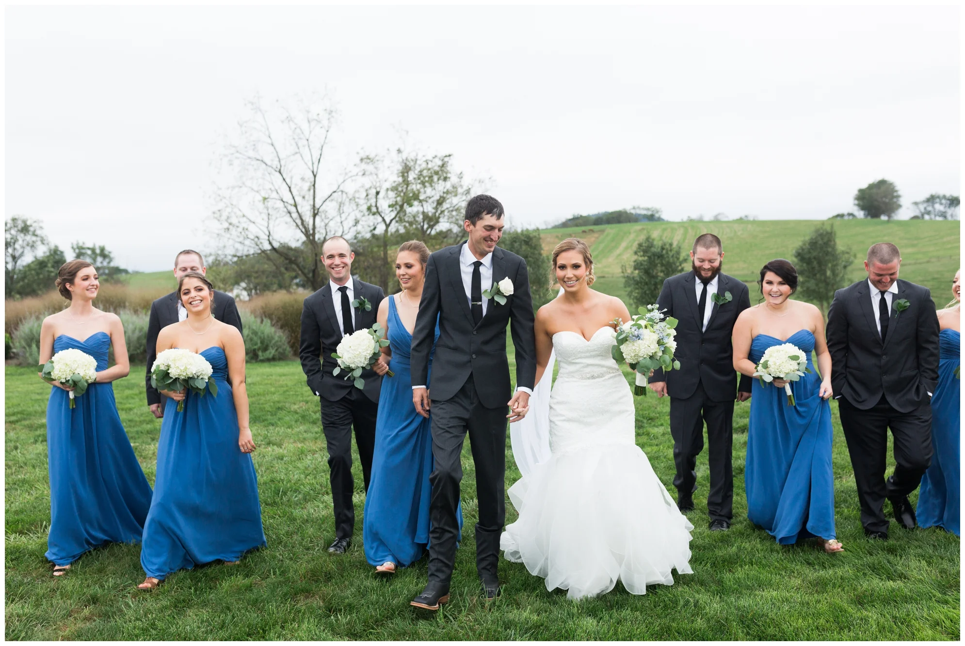 Rainy fall wedding featuring dusty blue bridesmaid dresses, bow ties and a cathedral veil at On Sunny Slope Farm in Harrisonburg, Virginia.
