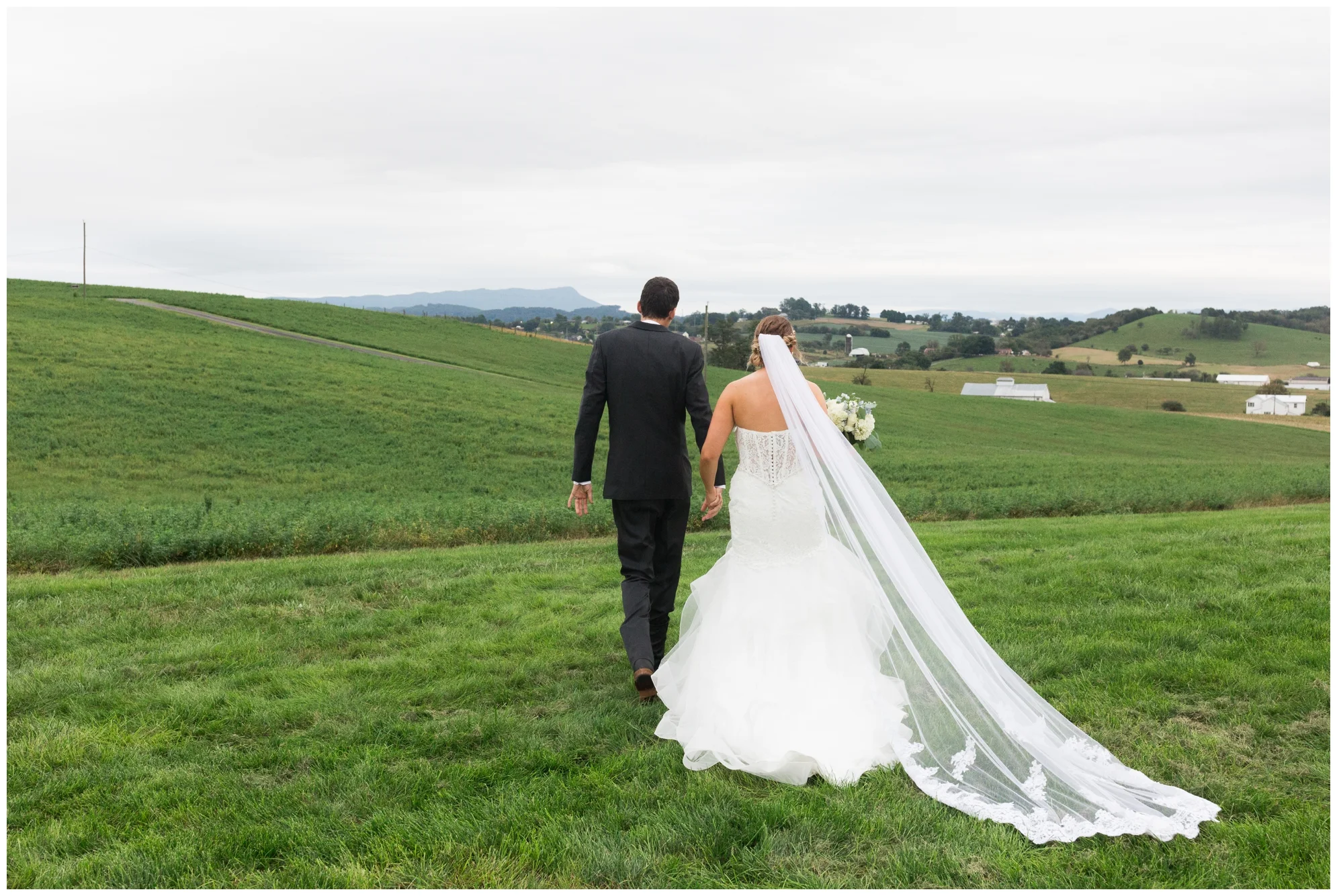 Rainy fall wedding featuring dusty blue bridesmaid dresses, bow ties and a cathedral veil at On Sunny Slope Farm in Harrisonburg, Virginia.