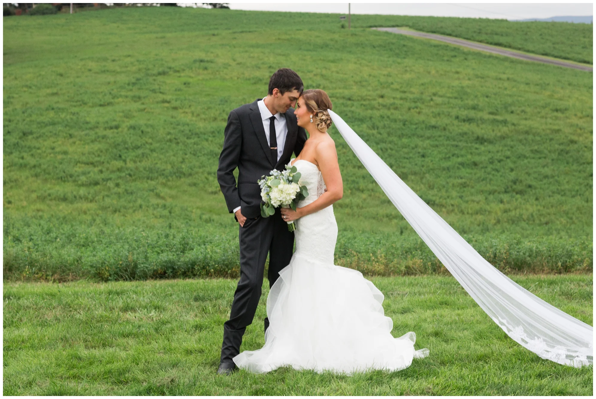 Rainy fall wedding featuring dusty blue bridesmaid dresses, bow ties and a cathedral veil at On Sunny Slope Farm in Harrisonburg, Virginia.
