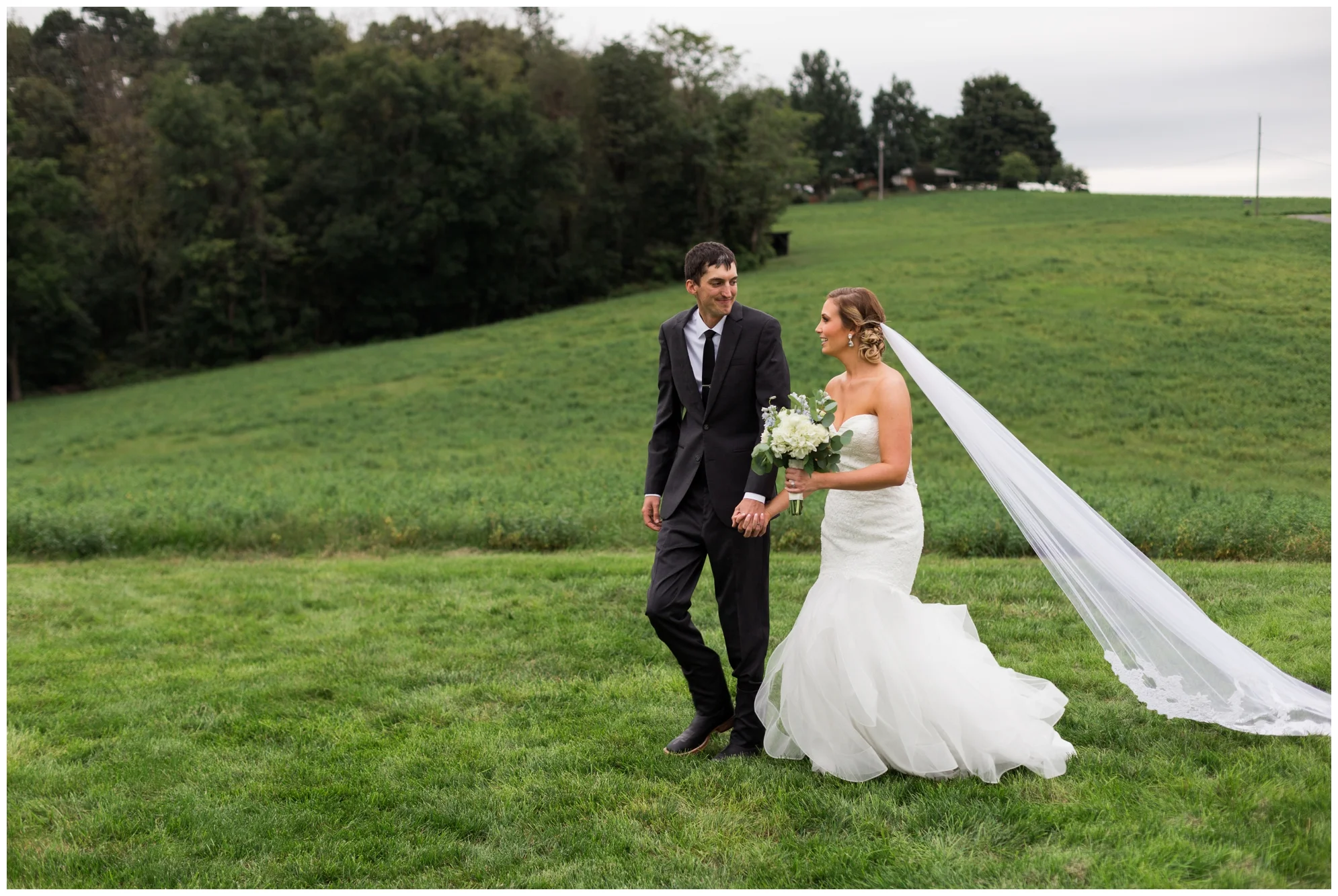 Rainy fall wedding featuring dusty blue bridesmaid dresses, bow ties and a cathedral veil at On Sunny Slope Farm in Harrisonburg, Virginia.
