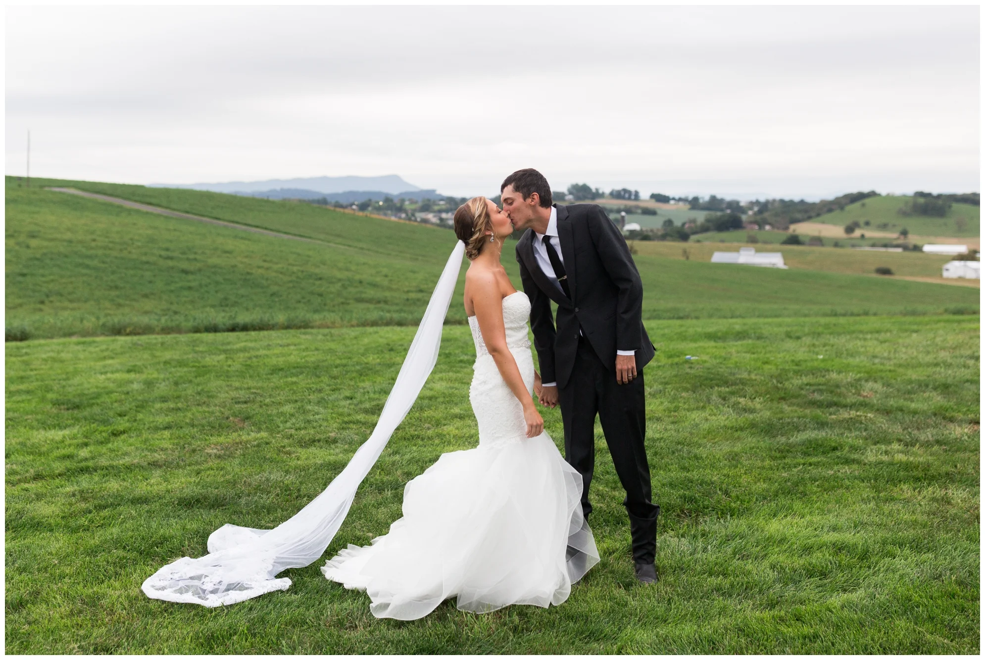 Rainy fall wedding featuring dusty blue bridesmaid dresses, bow ties and a cathedral veil at On Sunny Slope Farm in Harrisonburg, Virginia.
