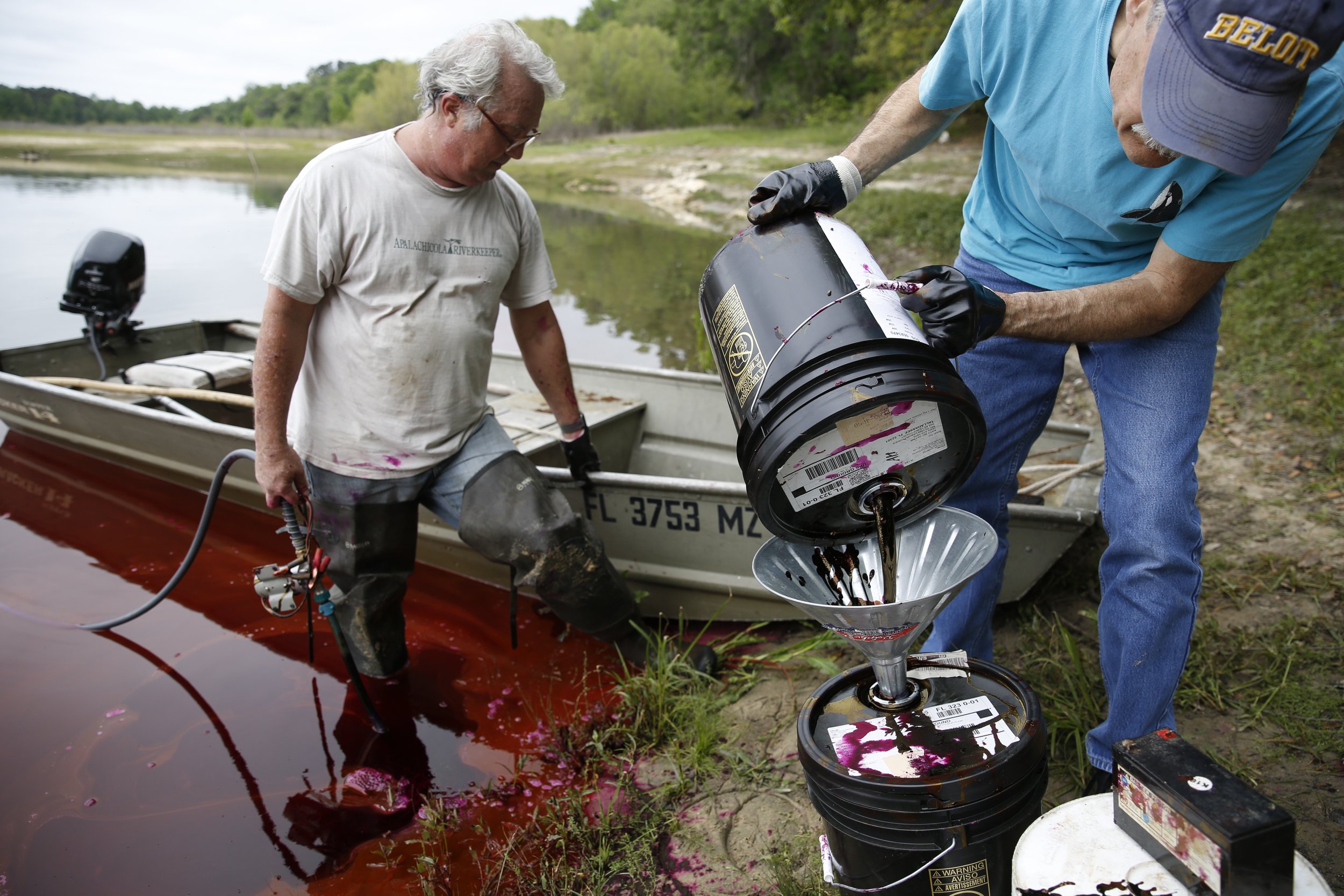  Wakulla Springs Alliance Chair Sean McGlynn, left, and Bob Deyle prepare to pump a non-toxic dye into a sink hole on Upper Lake Lafayette in Tallahassee, Fla., on Monday, April 9, 2018, as part of a study that seeks to better understand the connecti