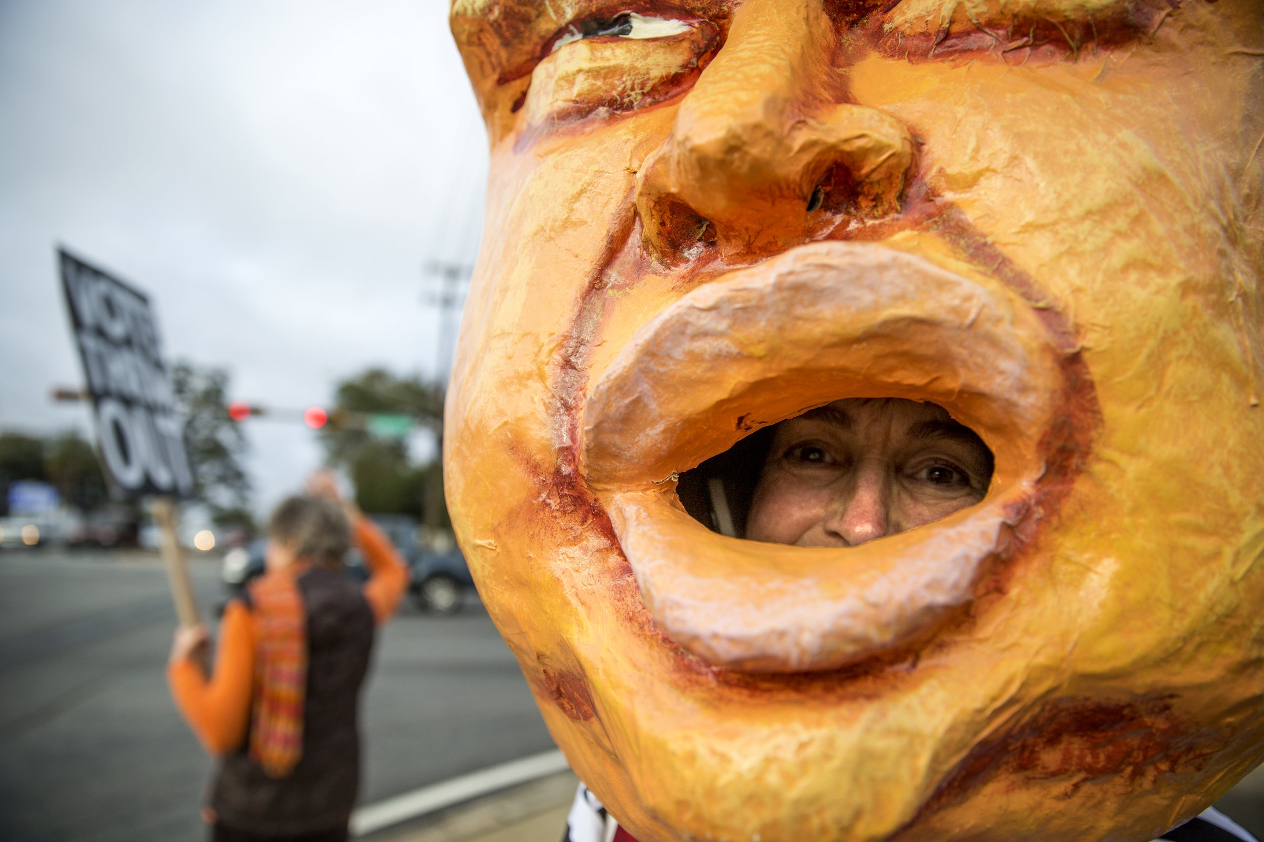  Ruthie Chase of the Stone Soup Street Action Committee dons a paper mache head for an Inconvenient Thursday Street Action at a busy intersection on Tallahassee, Fla., on Feb 8, 2018. The group has been taking to street corners every Thursday since t