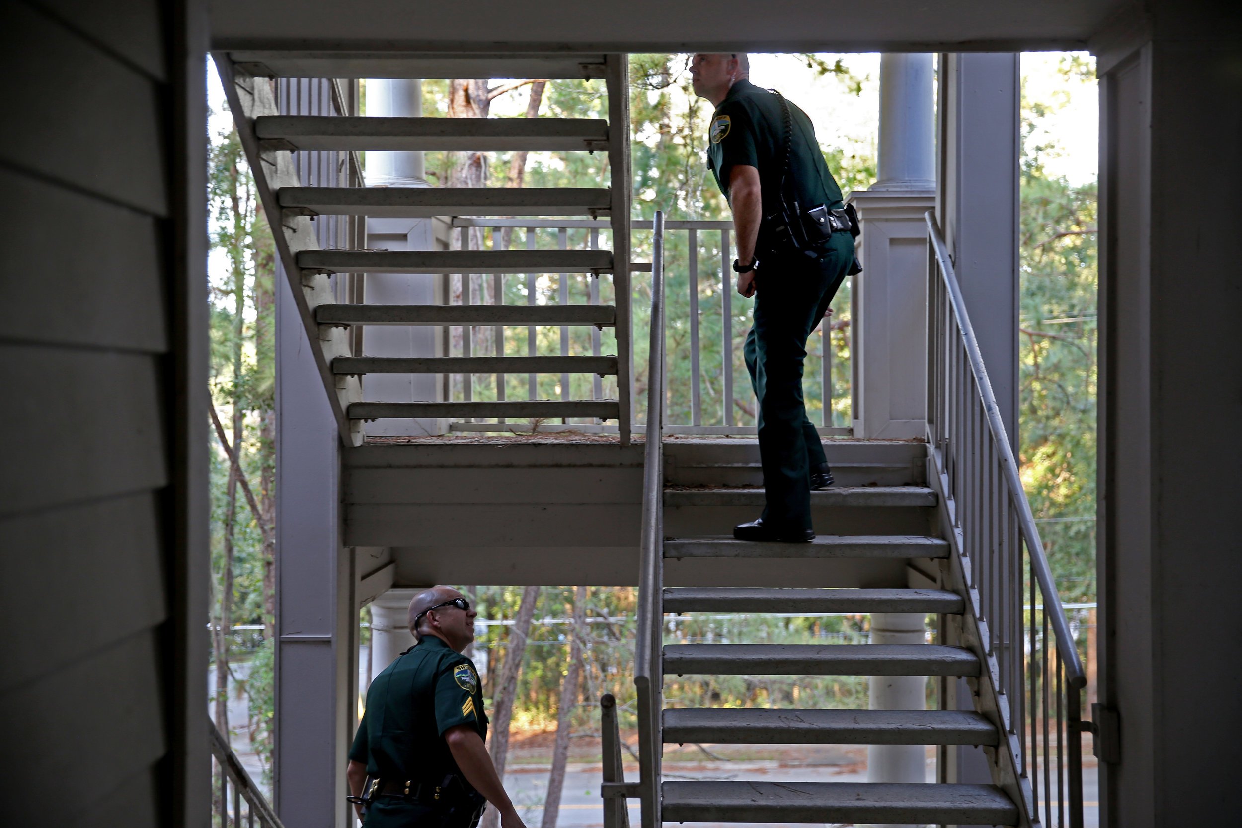  Leon County Sheriff's Office Sgt. Chris Poole, left, and Deputy John Baas search an apartment complex for a man with outstanding warrants Oct. 10, 2017. 