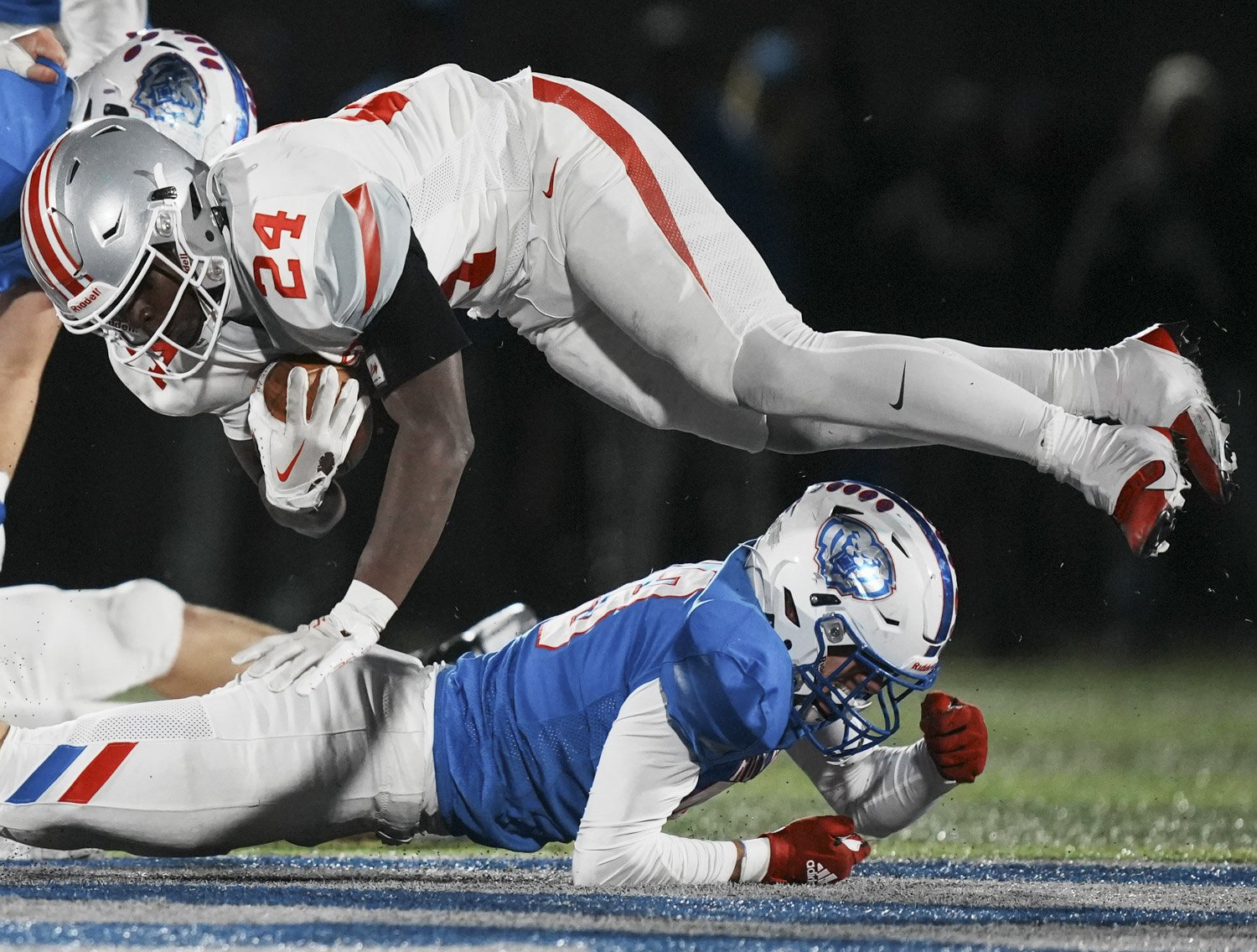 Fishers Tigers running back Khobie Martin (24) is tripped up by Royals’ defenders during the final game of class 6A sectionals between Fishers Tigers and Hamilton Southeastern Royals on Friday, Nov. 3, 2023, at Hamilton Southeastern High School in F