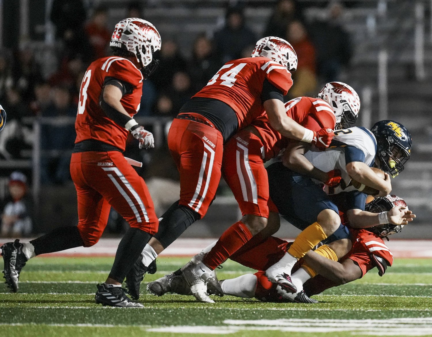  Mooresville Pioneers Hogan Denny (2) is sacked by a pile of New Palestine Dragons defenders during the IHSAA Class 4A Regional Championship game on Friday, Nov. 10, 2023, at New Palestine High School in New Palestine, Ind. Dragons defeated Pioneers 