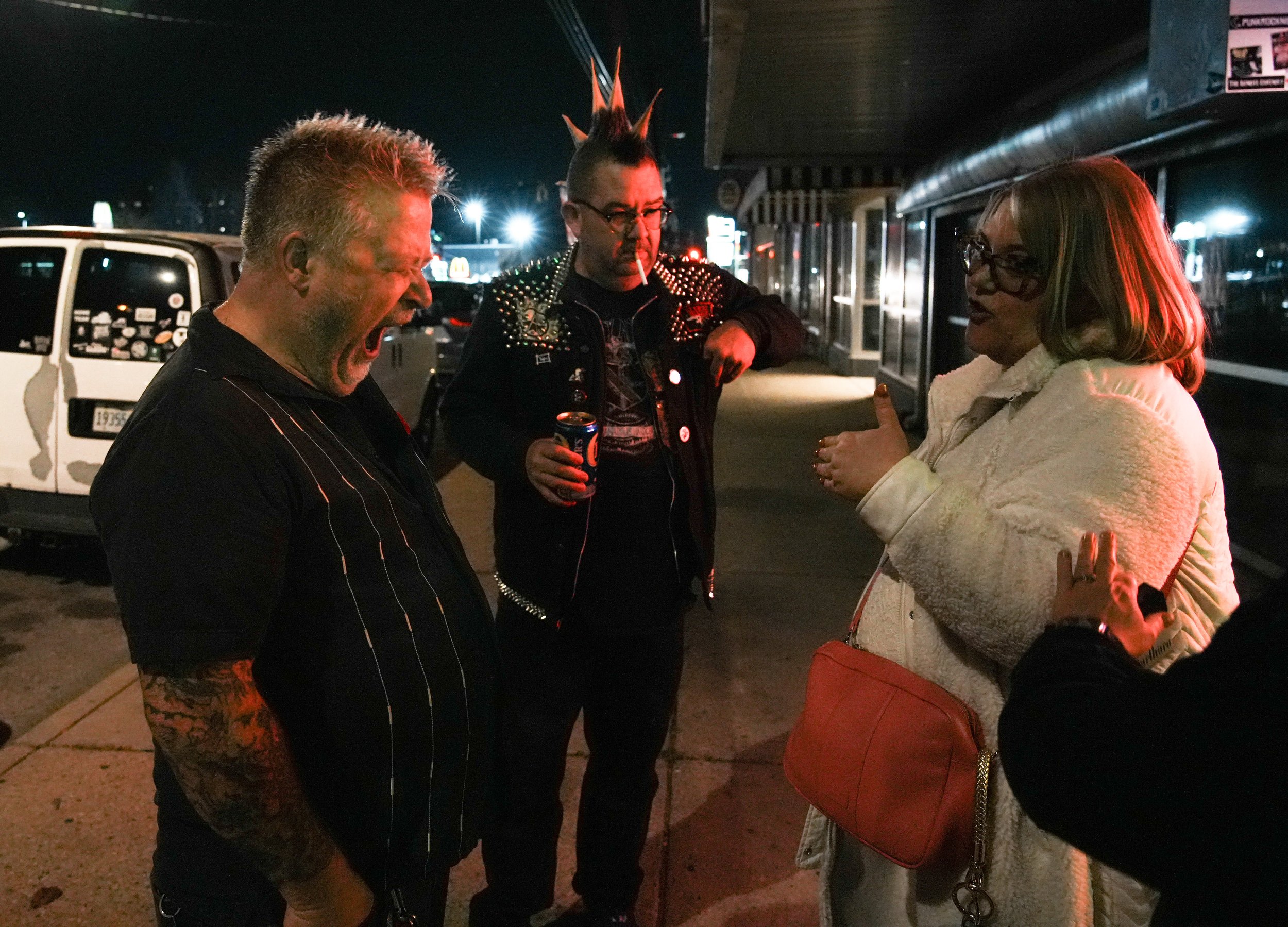  J.J.Pearson yawns while visiting with friends Saturday, Nov. 11, 2023, after playing a show at the Melody Inn in Indianapolis. Accustomed to working during the night and sleeping during the day, Pearson was tired after missing a daytime nap in order