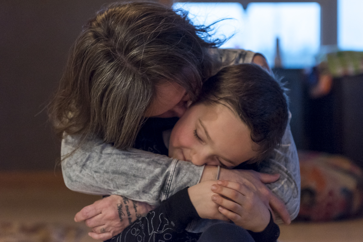  DJ Fuller, a mother of seven adopted trauma children, holds her youngest son Levi in her arms at their home in Amesville, Ohio. 