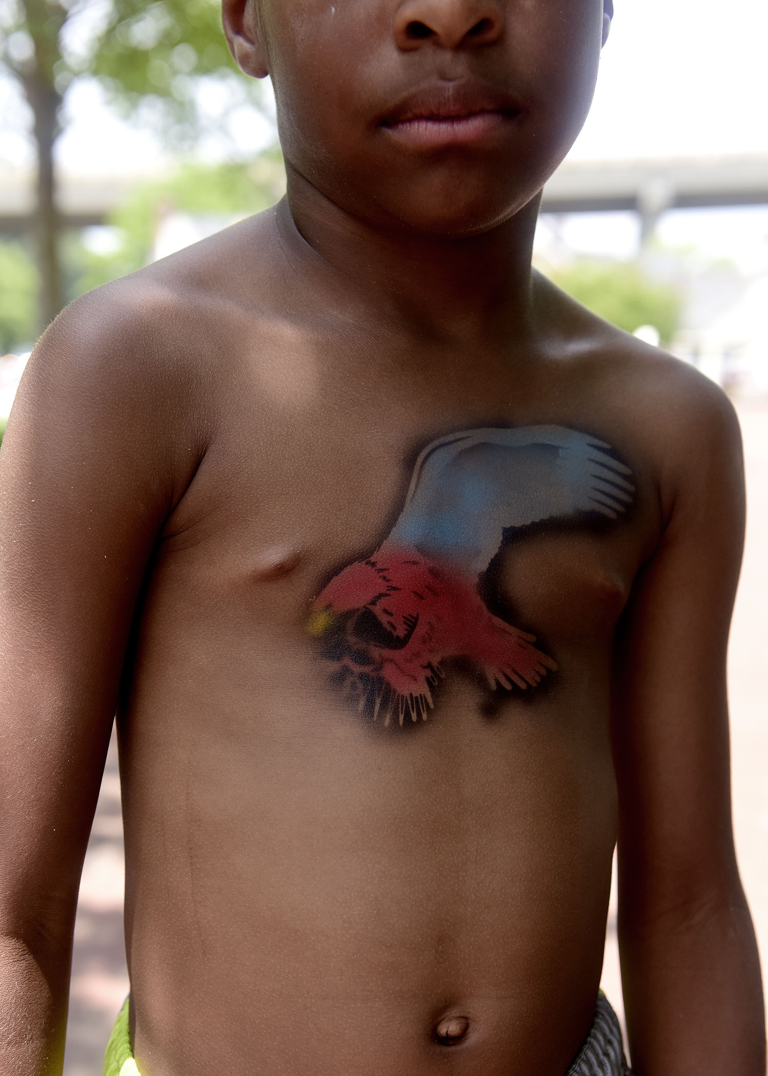  Marcus Anderson poses for a portrait with a red, white and blue eagle he got airbrushed on his chest at Yorktown Beach on Thursday, July 4, 2019. 