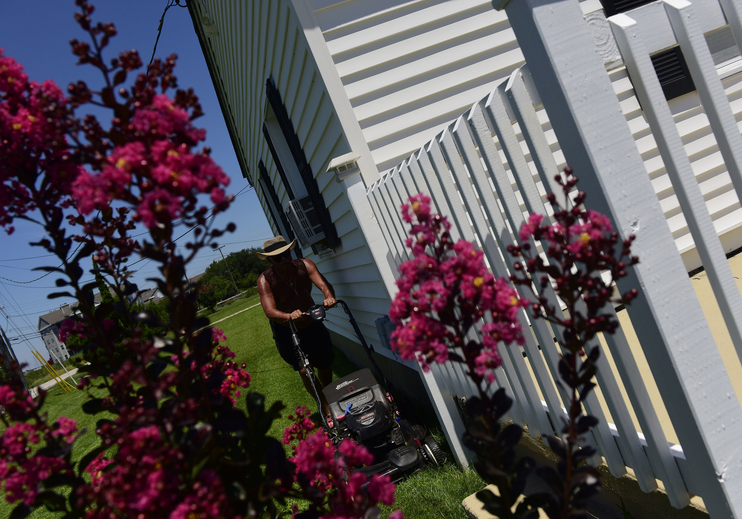 Mike Smith cuts his grass at his home in Hampton on Monday, July 15, 2019.