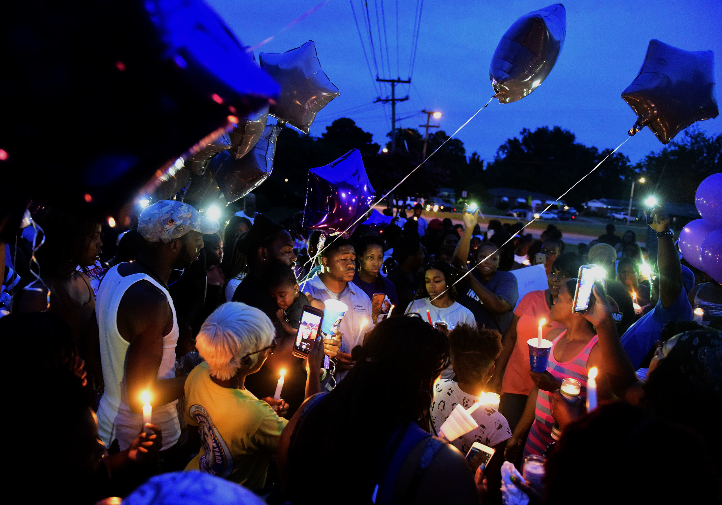  Family members, friends and members of the community gather to light candles and release balloons to celebrate the life of 17-year-old, Nye’Tazia Hicks, in Portsmouth, Virginia on Thursday, August 1, 2019. 