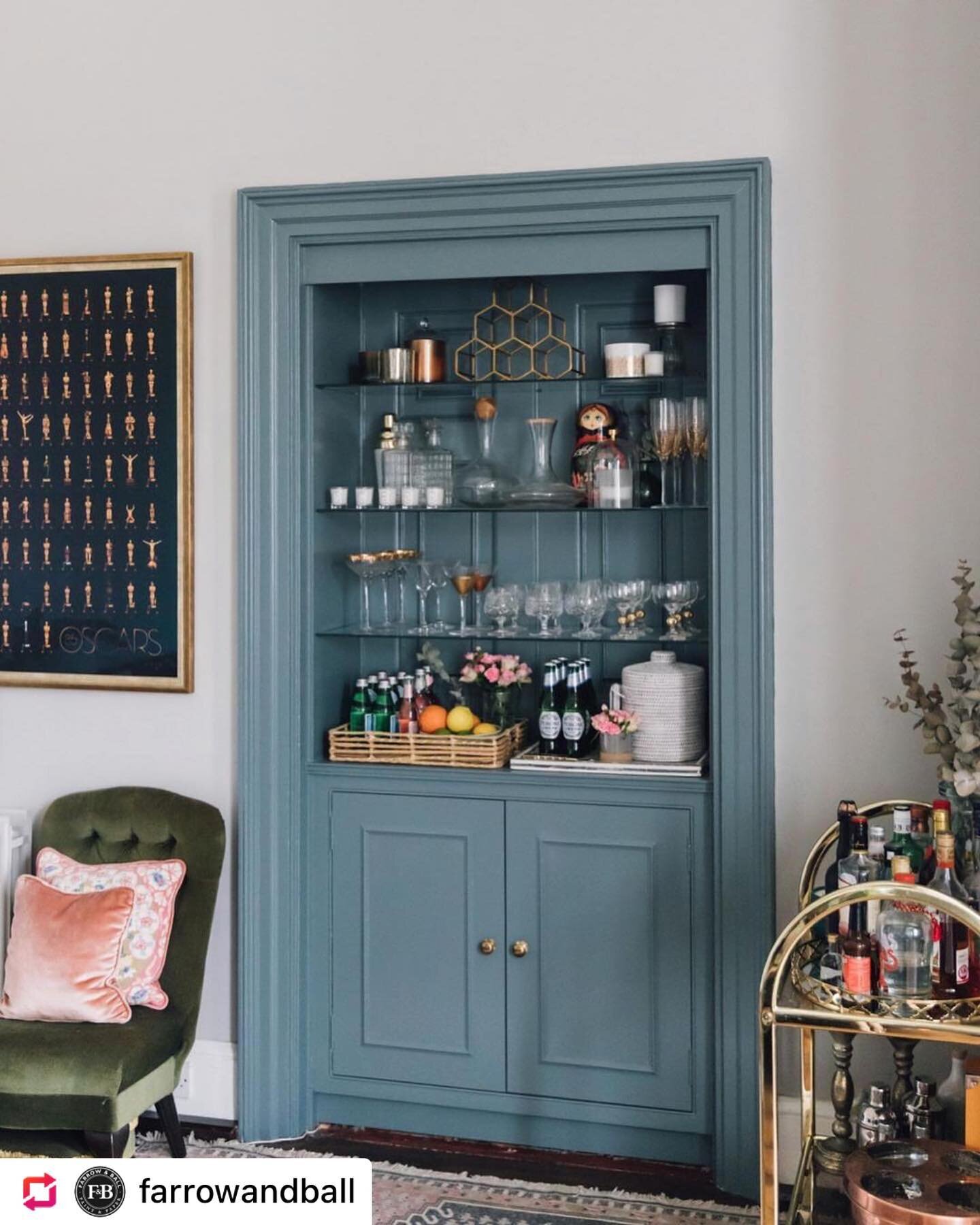 #farrowandballfriday and a cheers to the weekend! This clever built-in bookcase bar, painted in #DeNimes, perfectly tucks away into a #PavilionGray living room. 
.
Such a cool, sophisticated color combination! What do you think? Tell us in the commen
