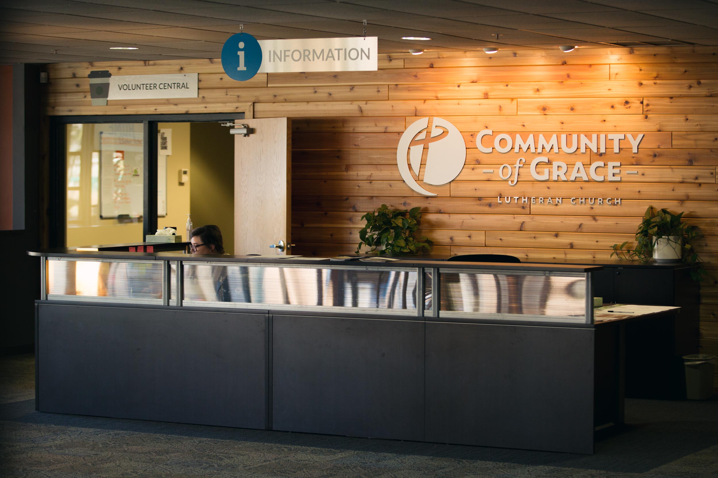 Branded reception desk wall at Community of Grace