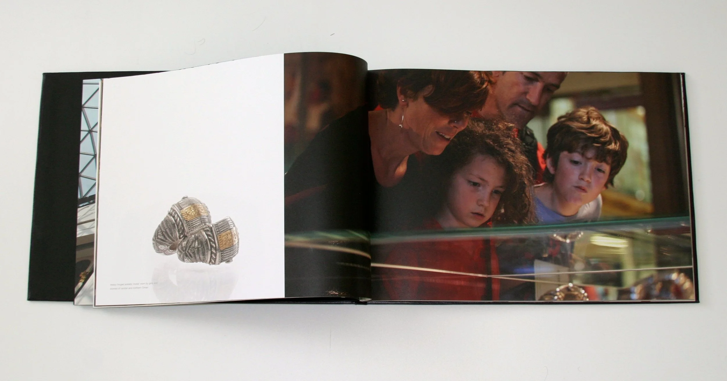  Commemorative book, featuring photographs capturing a day-in-the-life of the exhibition, showed visitors enjoying the Adornment and Identity display.    