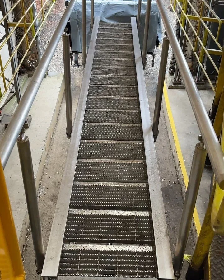 Fun project for our transload customer in Worcester, MA. Problem: get into the train cart when empty to install a plastic liner, then get into the cart once full to close up the liner.  Solution: hydraulic actuated stairs with hinged treads and raili