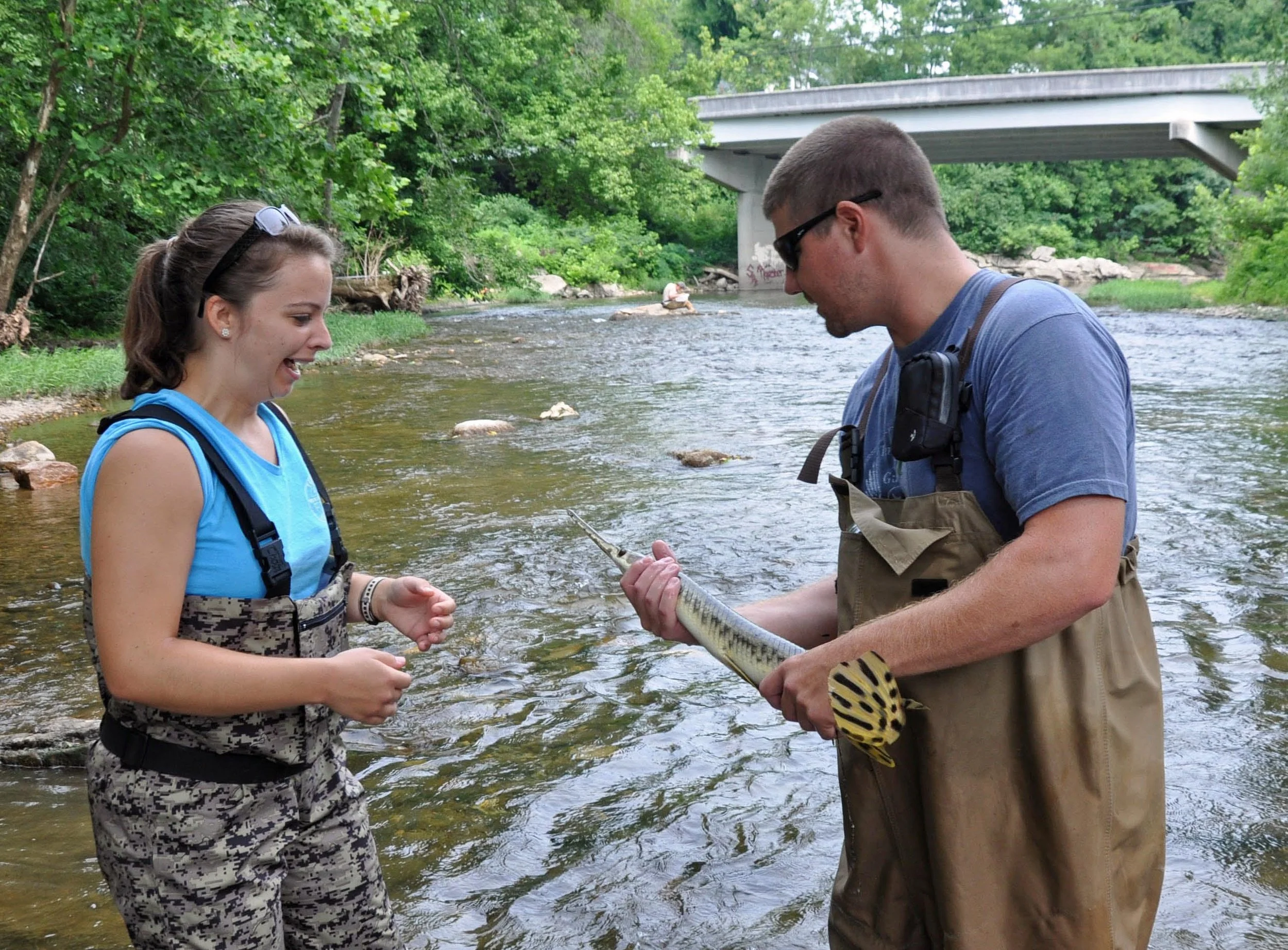 Gar Scream! Two environmental science volunteers examine a gar fish they had caught while doing a biodiversity study of the Little River in Walland, TN.