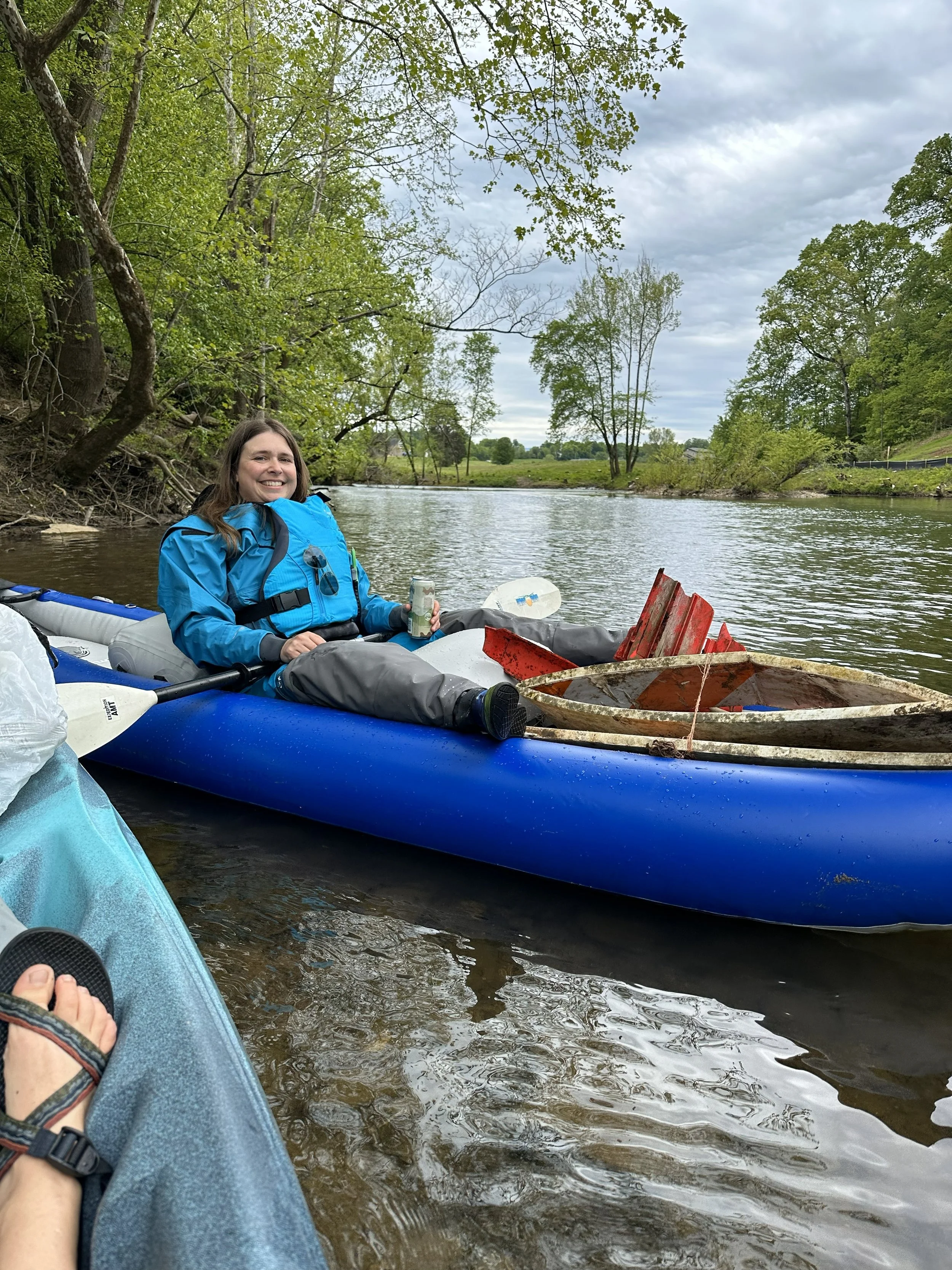 Kayaker removes trash from the Little River.