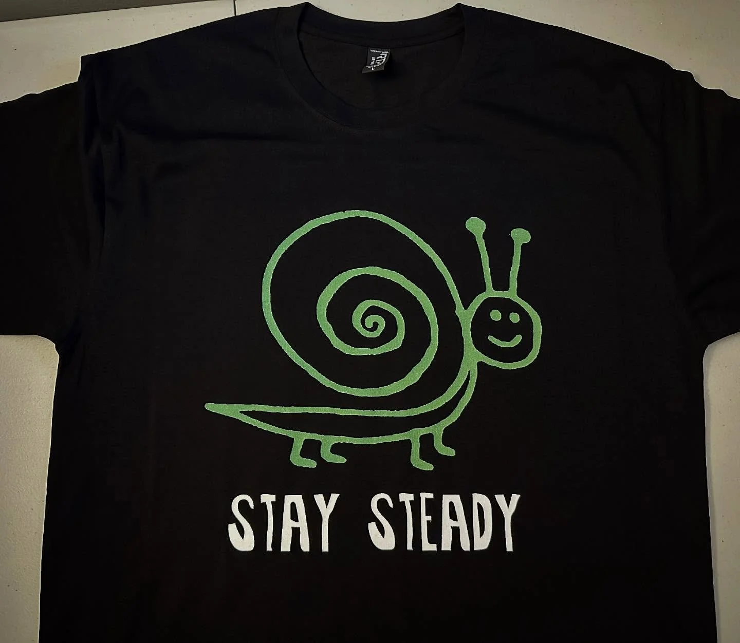 20% Off Sale Continues 
.
New shop addition : Stay Steady 
Black short sleeve tee 
.
#smallbusiness #evanston #staysteady #snail #tshirt #tshirtdesign #tshirtprinting