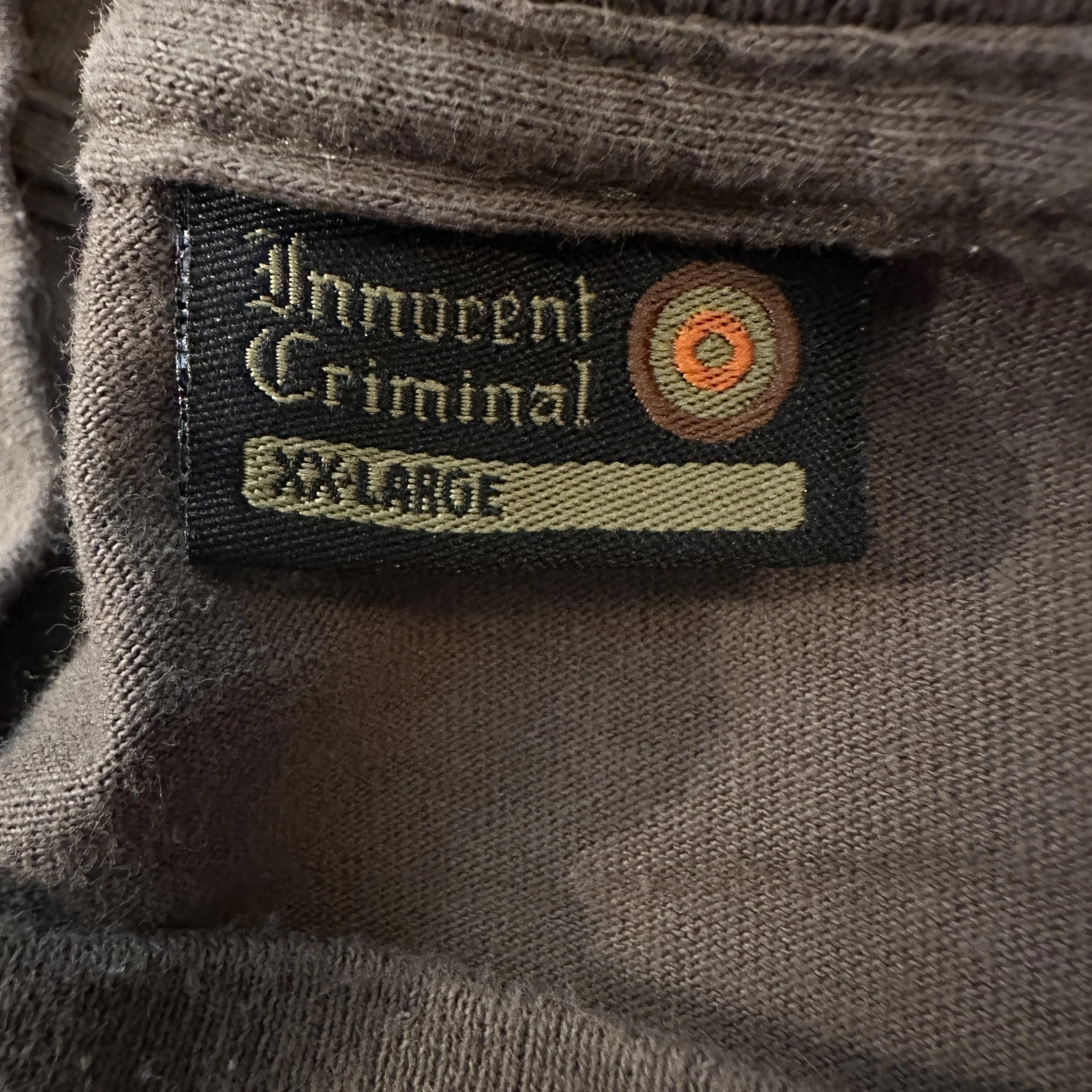 BHIC_Concealed_BothSidesOfTheGun_Olive_TShirt_LaundryTag.jpg