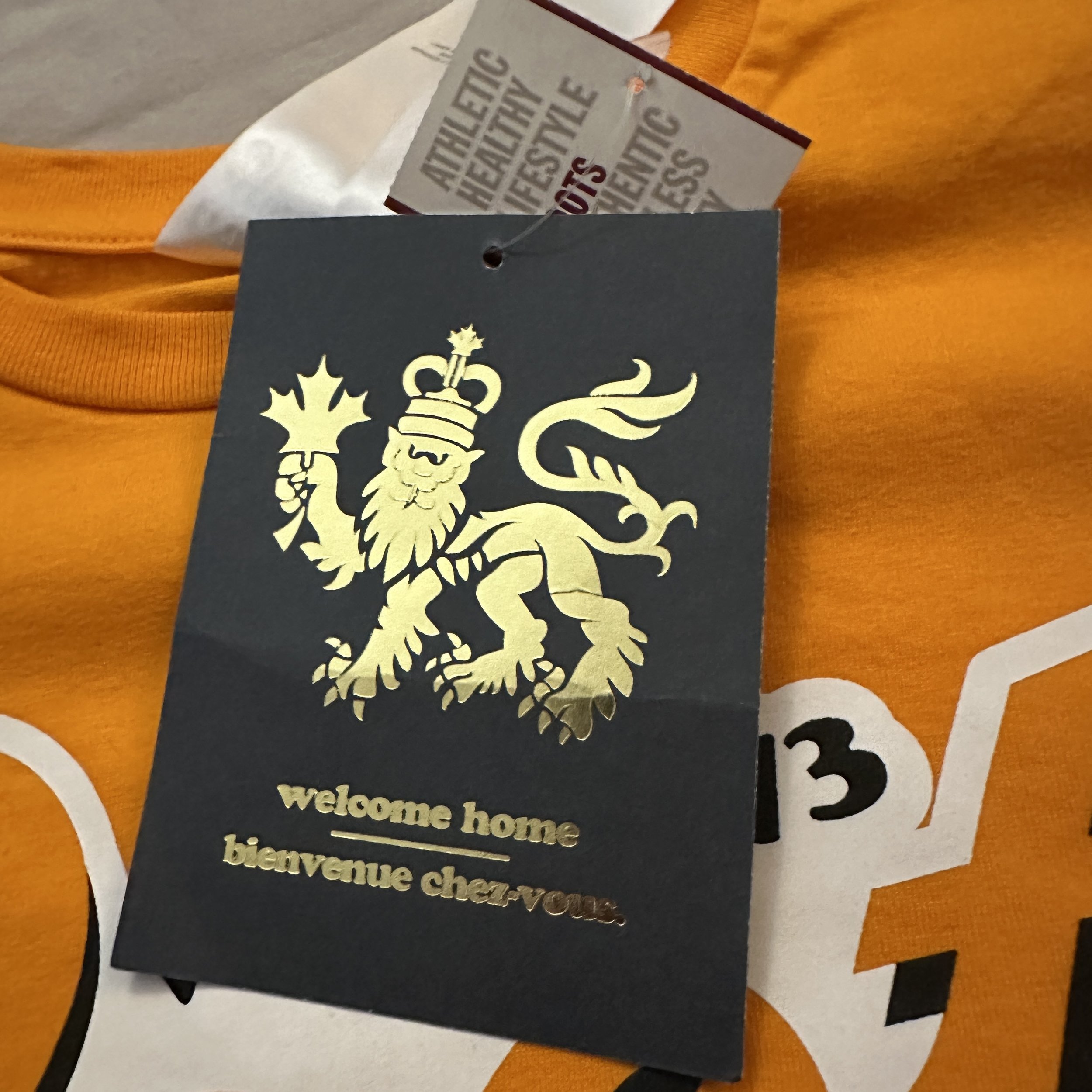 Roots_Vestigde_73_Orange_TShirt_HangTag.jpg