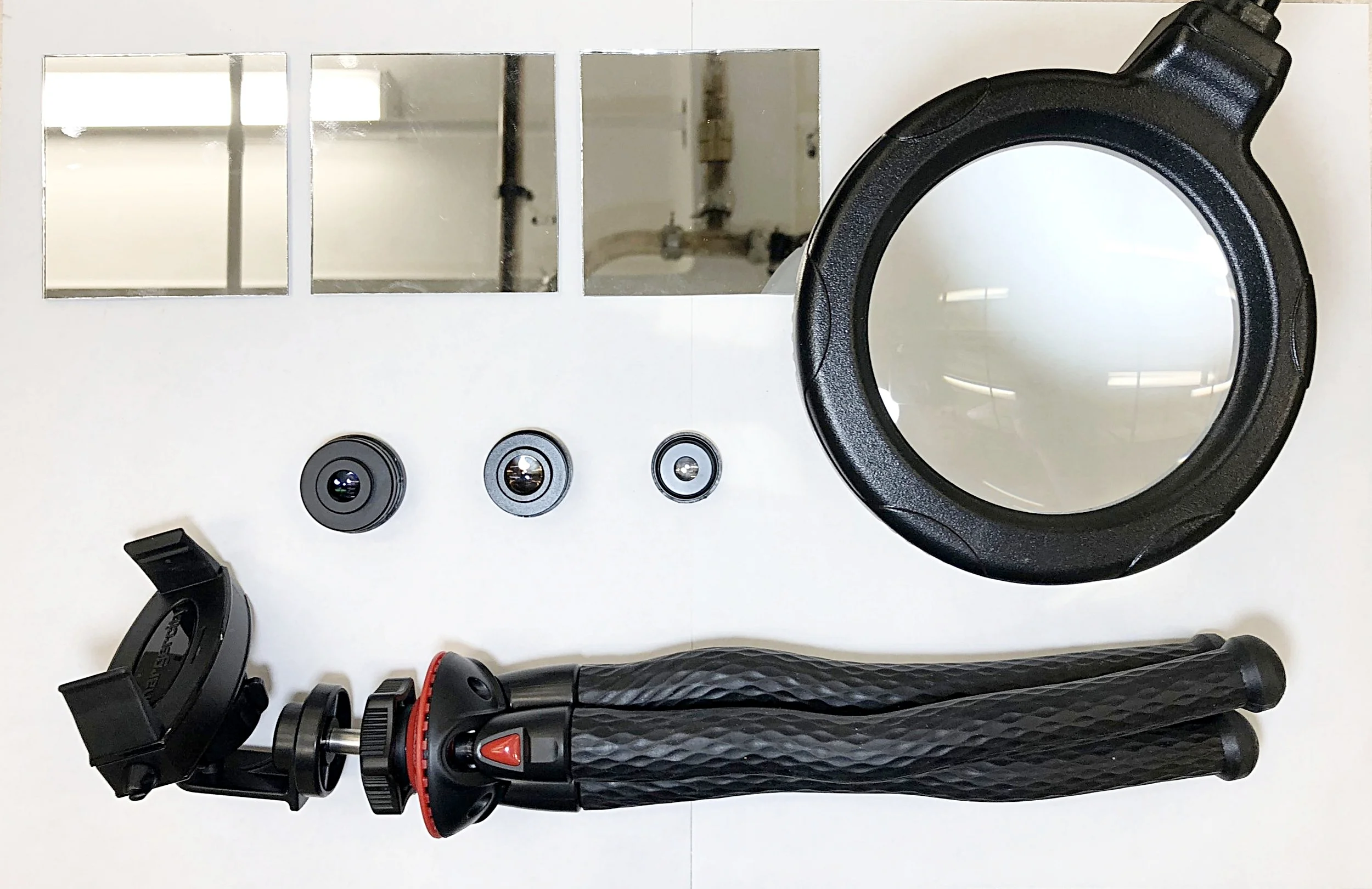 Figure 2: My setup that includes mirrors, lenses, an LED light, and flexible tripod.