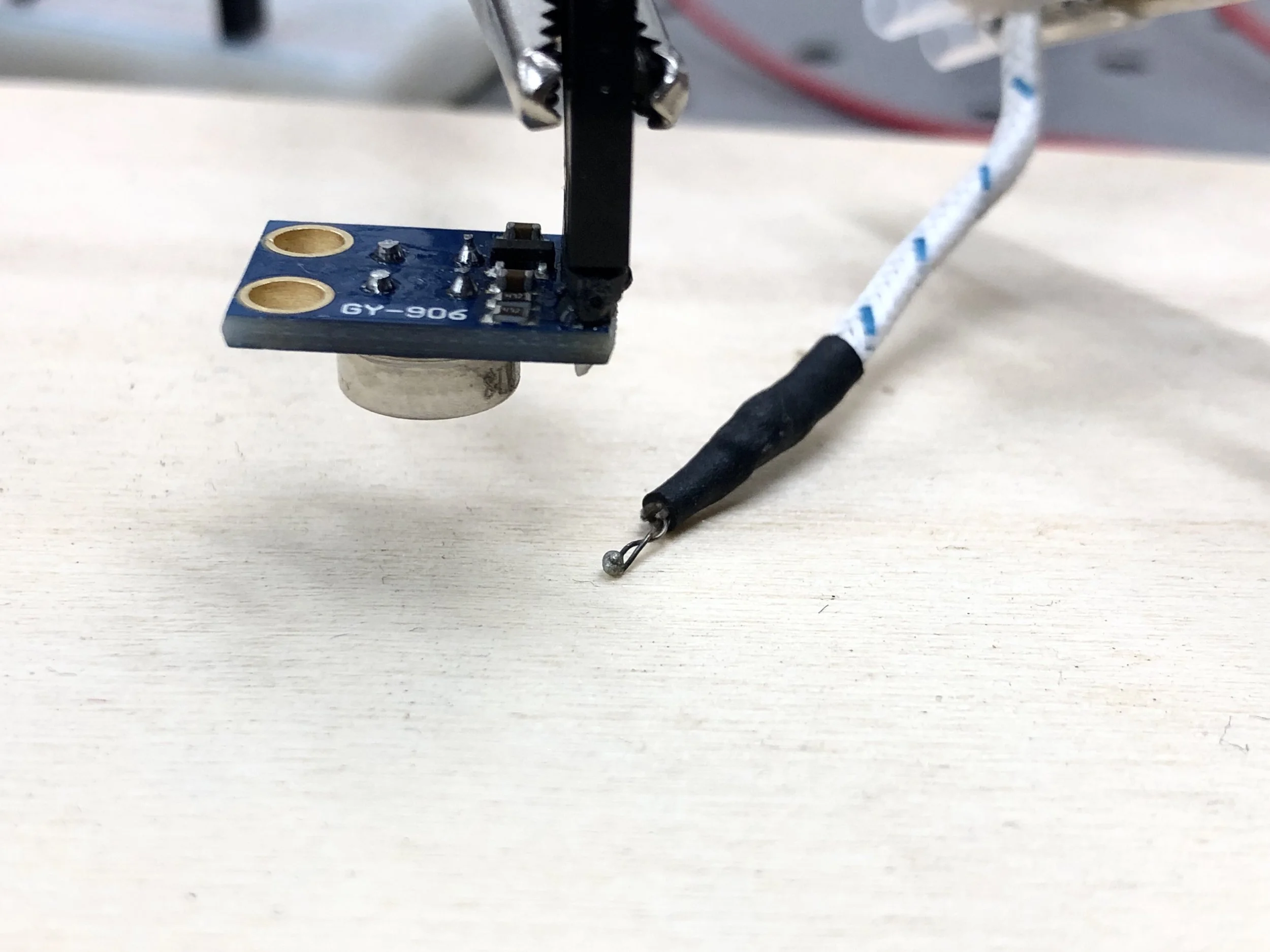 Using the MLX90614 and a thermocouple to measure temperature of a heated block of wood.