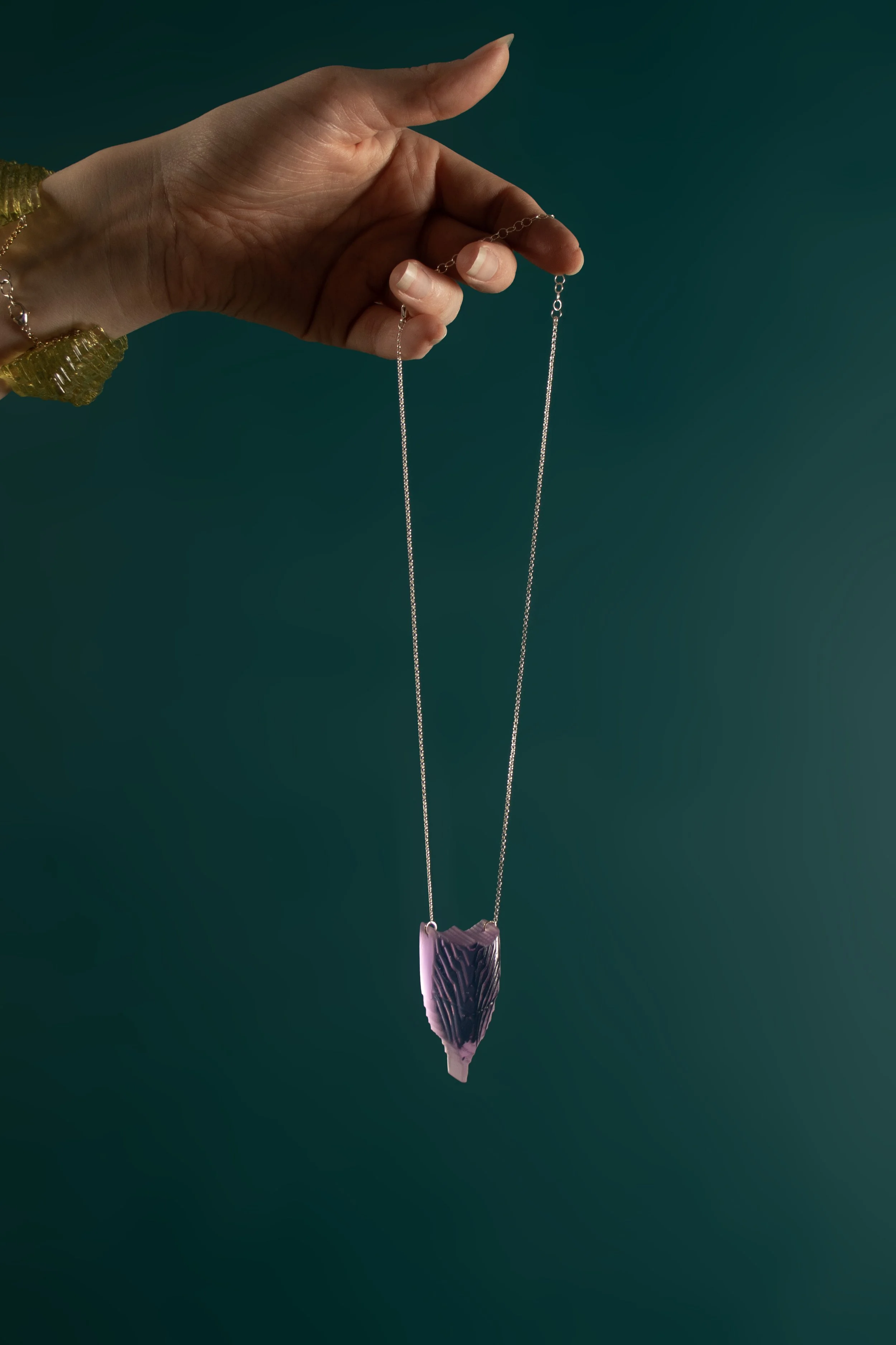 ElongatedMiniShieldinFuchsia_onteal.jpg