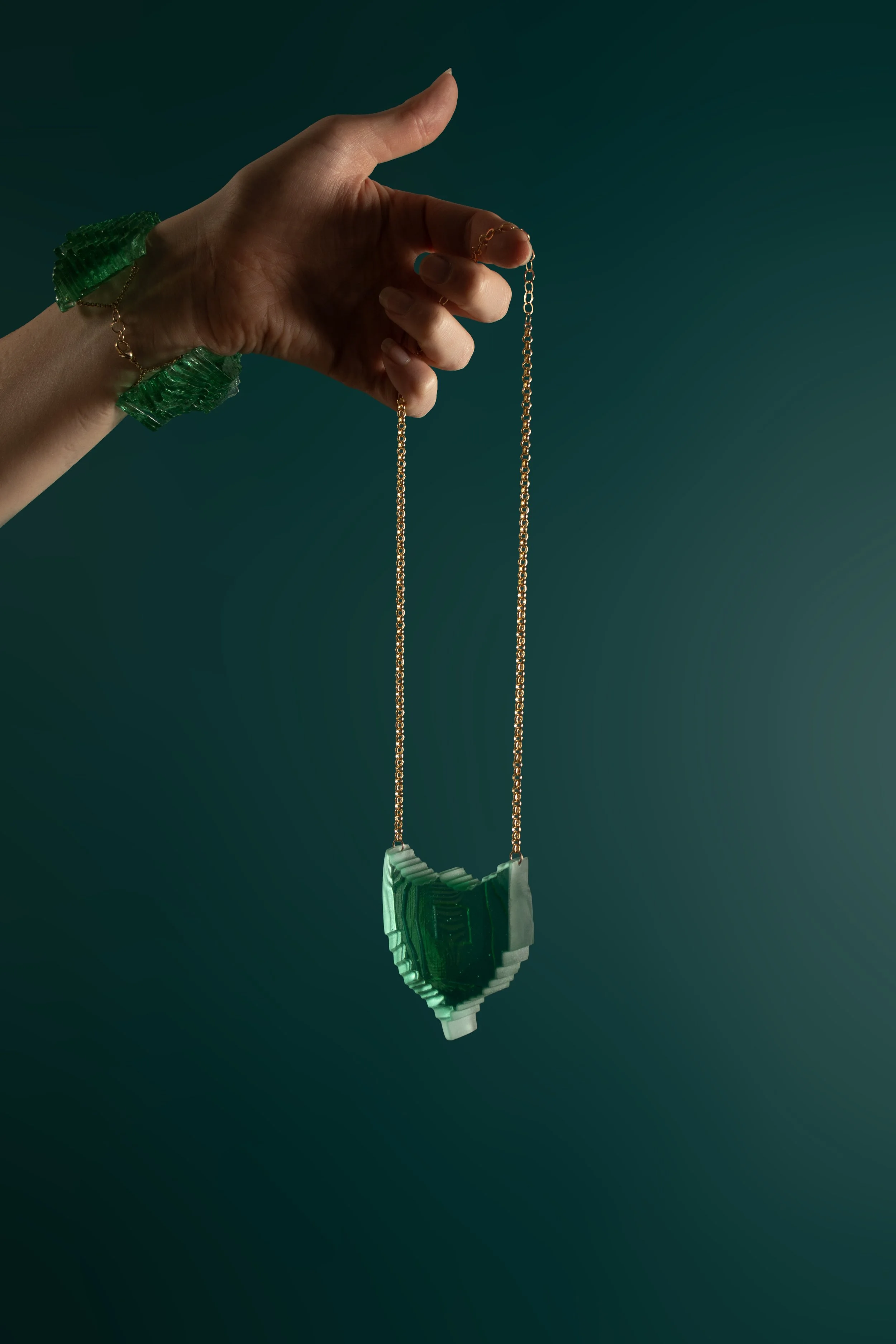 JadeShield_facingleft_onteal.jpg