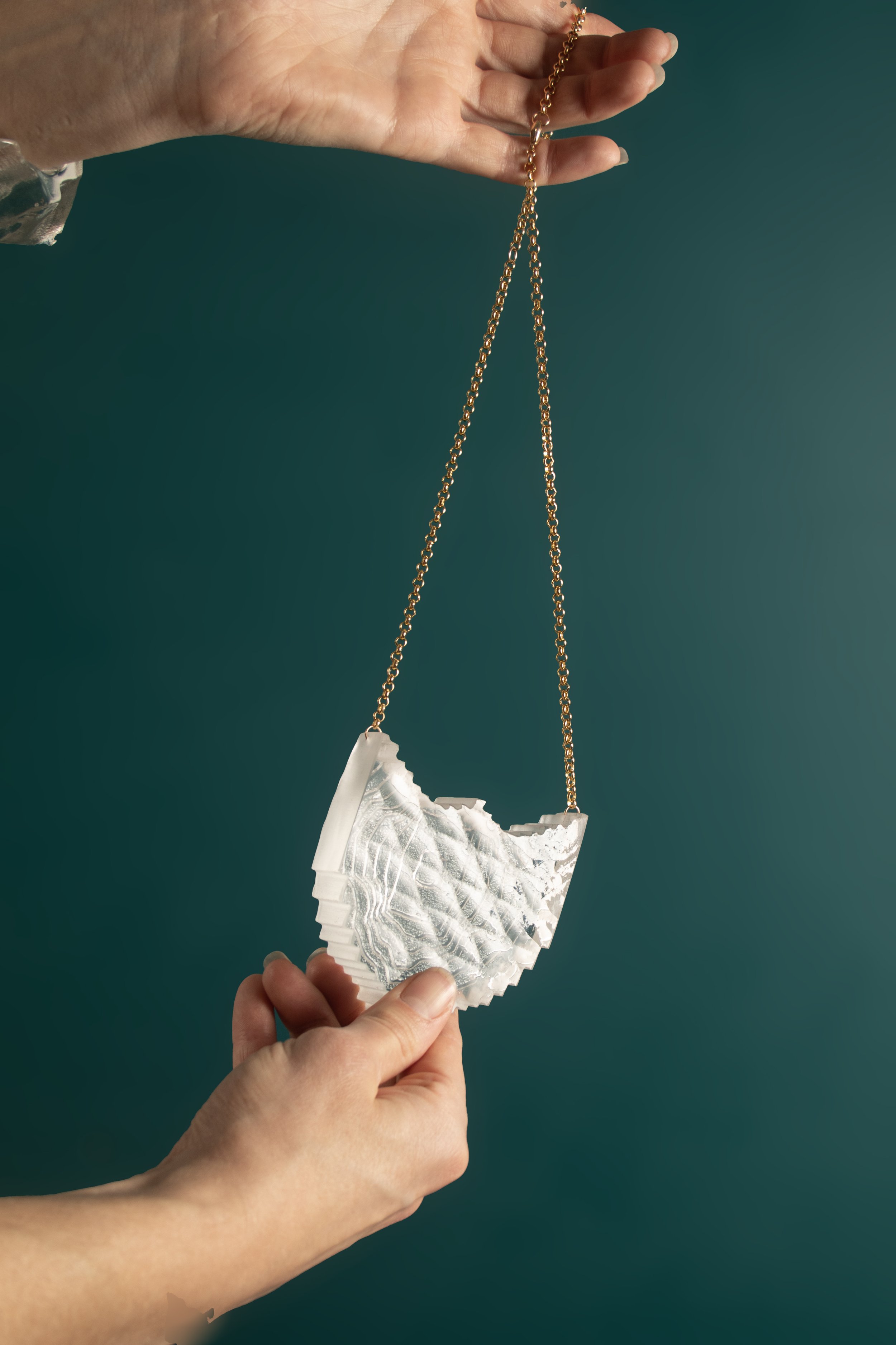PendantTextureShieldinClear_backtexture_onteal.jpg