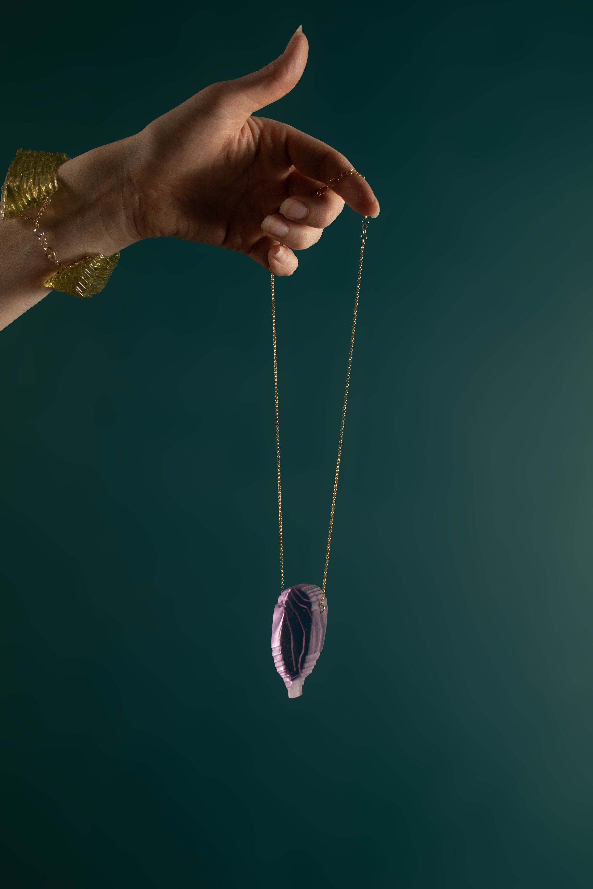 ElongatedRoundedShieldinFuchsia_angle_onteal.jpg