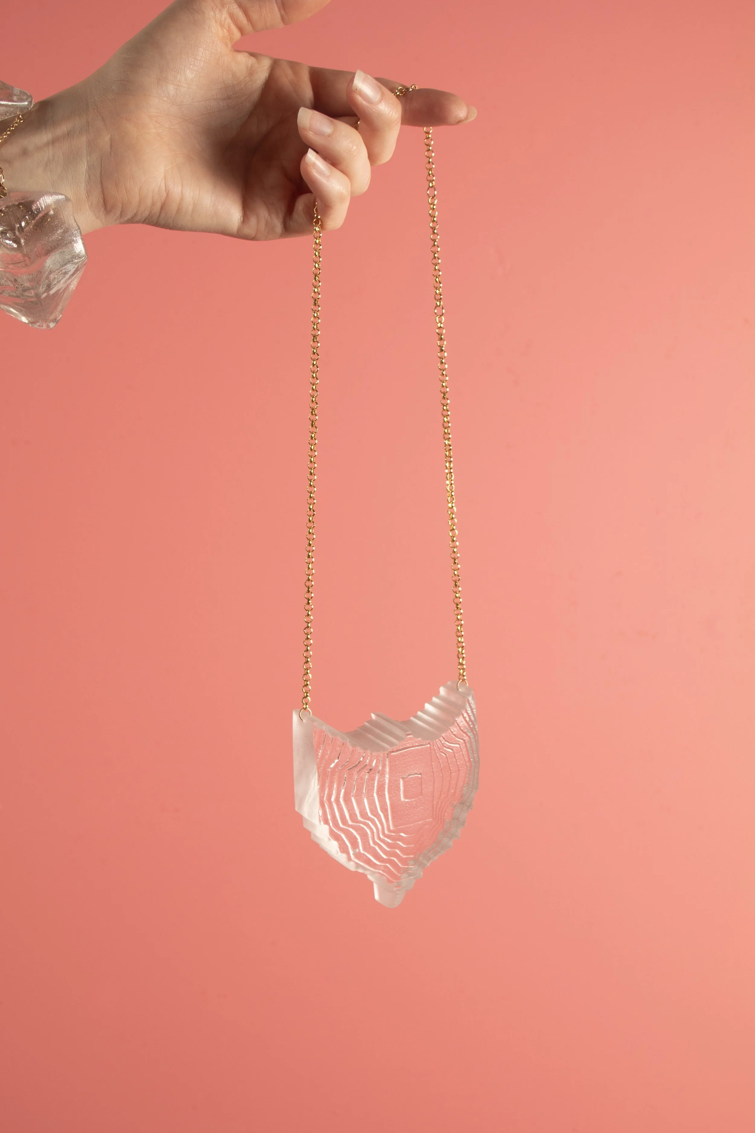 PendanttextureShieldinClear_onpink.jpg